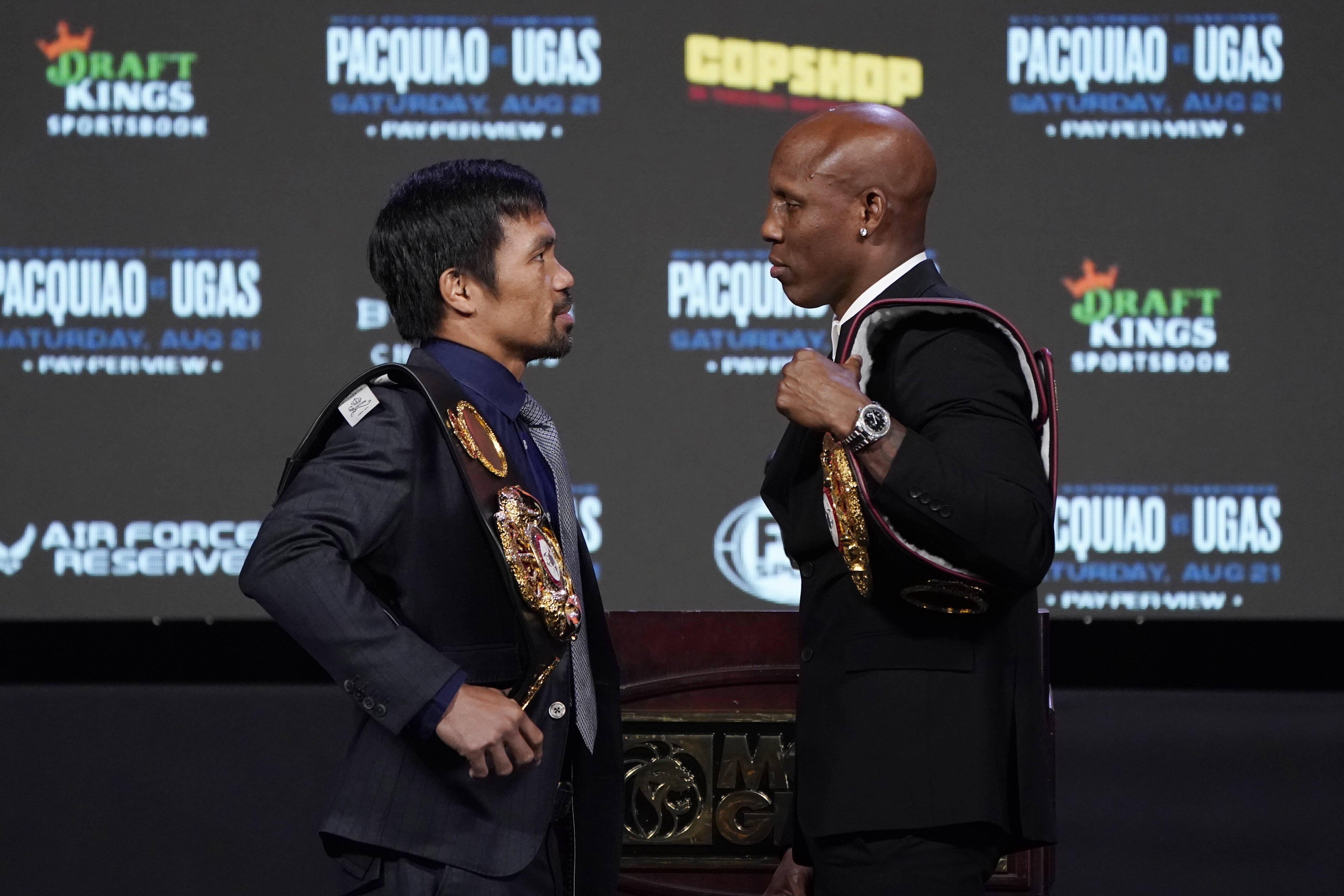 Manny Pacquiao (left) and Yordenis Ugas pose for photographers during a news conference in Las Vegas. Photo: AP
