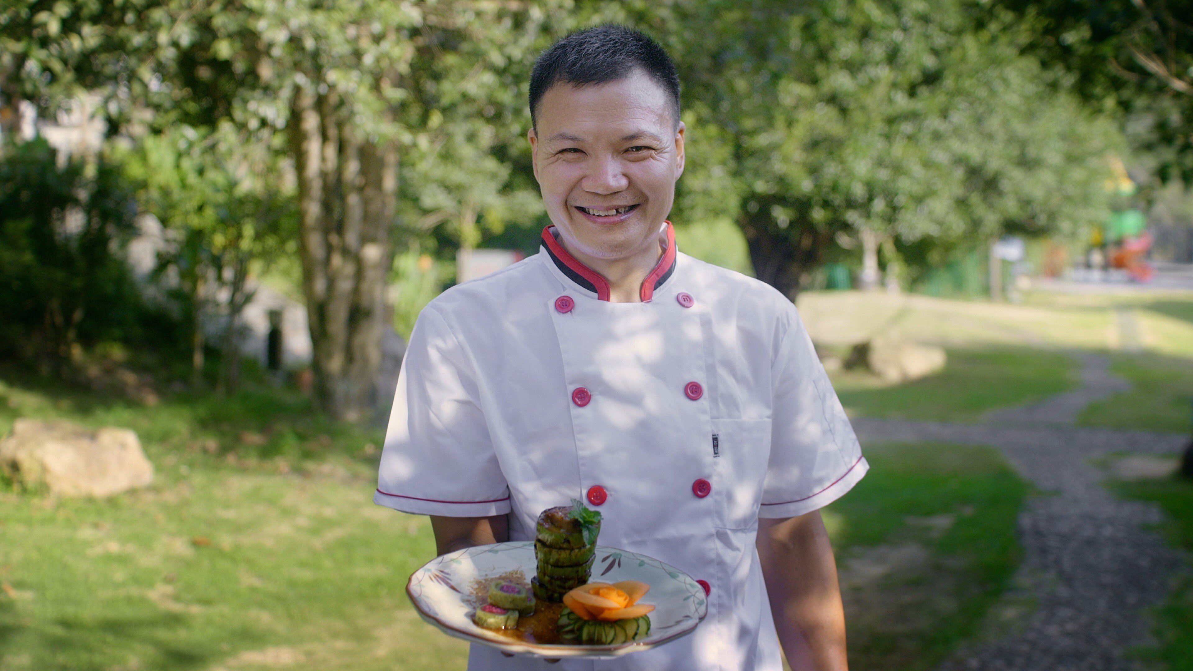 Chef Zhu Nengqing with his signature stuffed chayote dish, which is a popular item on the menu at Xueshan Linyuan Agritainment restaurant.