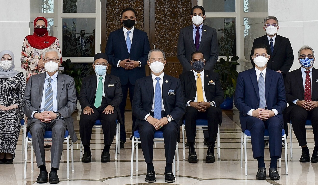 Malaysian Prime Minister Muhyiddin Yassin (C-front) and Deputy Prime Minister Ismail Sabri Yaakob (C-L) pose for a photograph with cabinet ministers. Photo: EPA-EFE