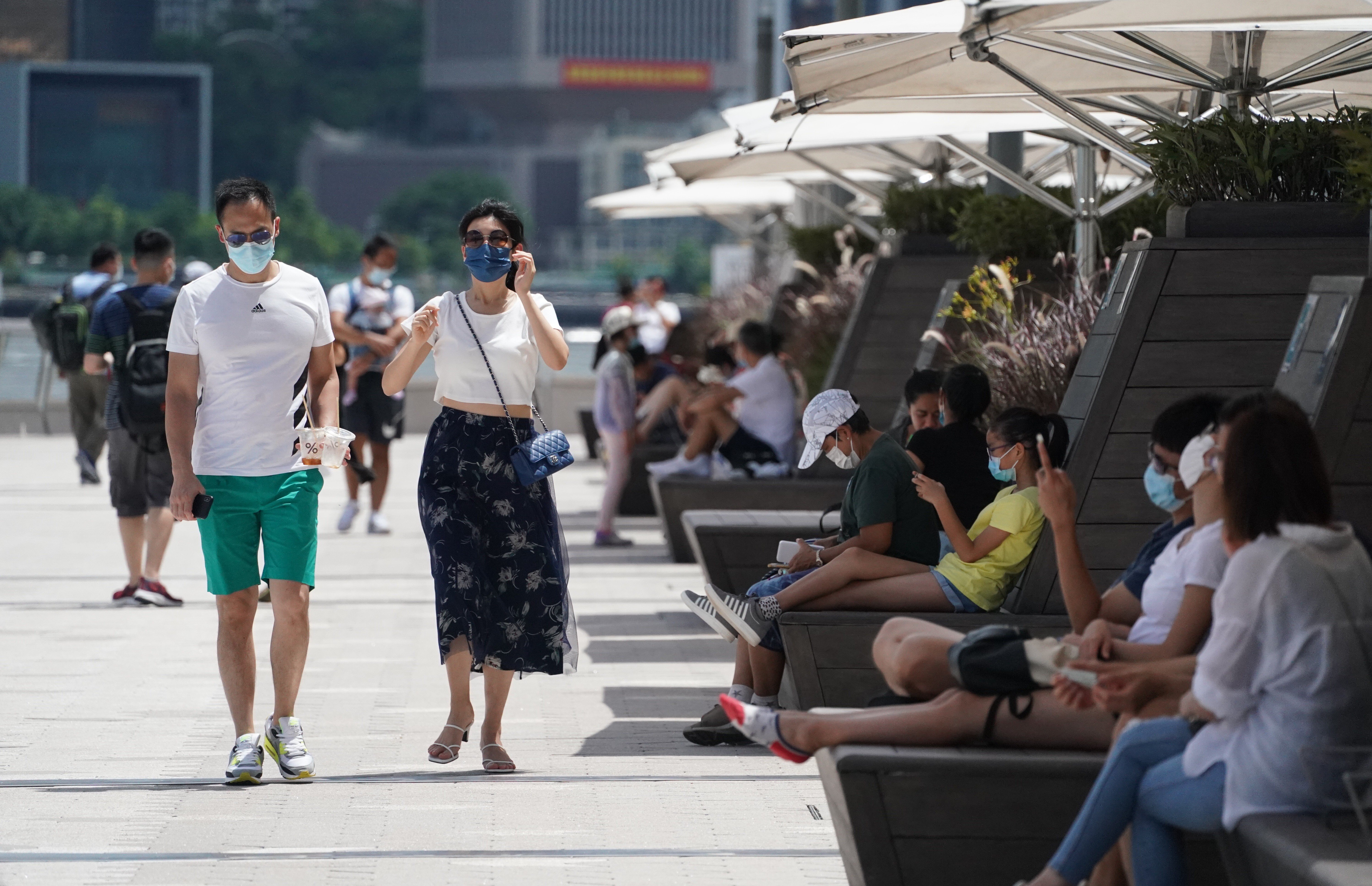 People enjoy the sunshine along the Tsim Sha Tsui waterfront. Hong Kong’s health minister says residents expect authorities to maintain a ‘zero cases’ Covid-19 policy. Photo: Felix Wong