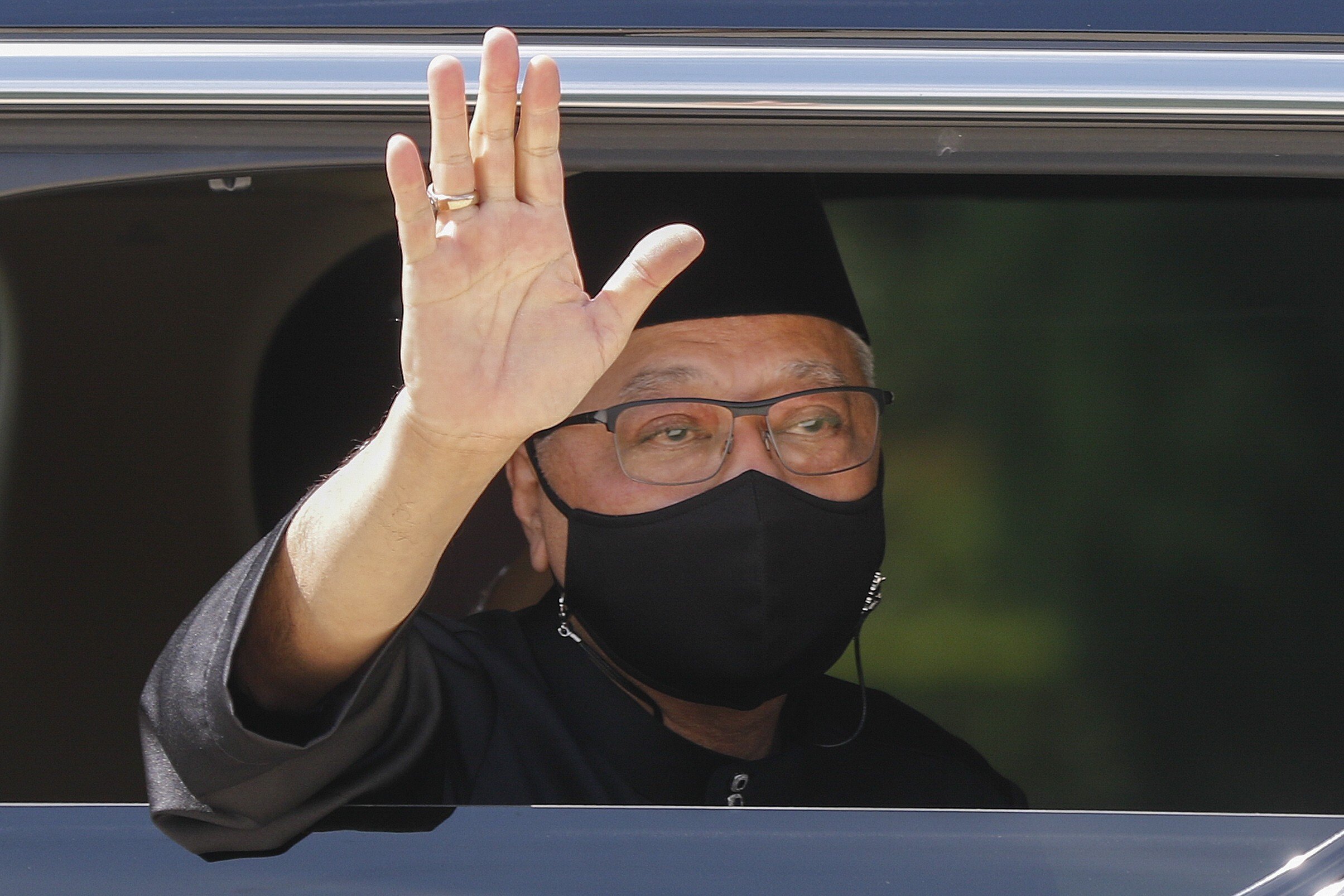 New Malaysian Prime Minister Ismail Sabri Yaakob waves from a vehicle as he leaves the National Palace after his swearing-in ceremony on Saturday. Photo: EPA-EFE