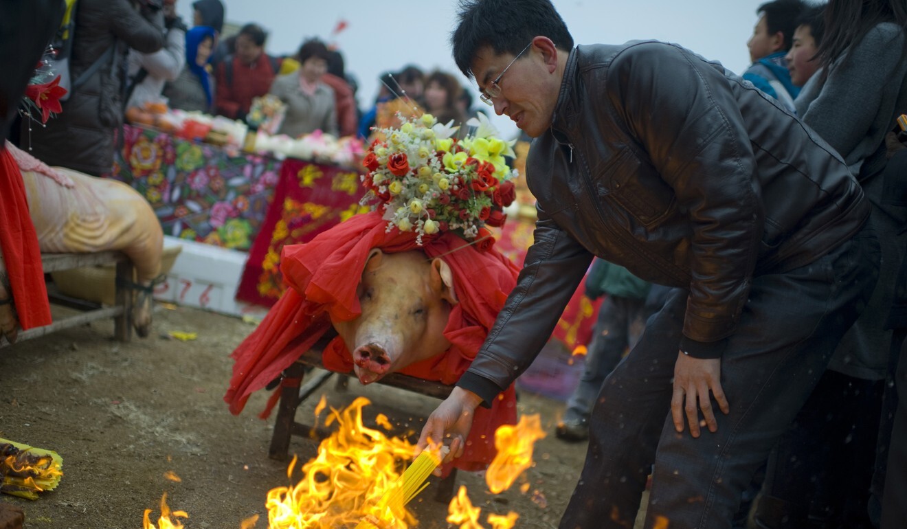 People in China burn joss paper at a festival ahead of fishing season in the hopes that it will bring them good luck. Photo: Getty Images