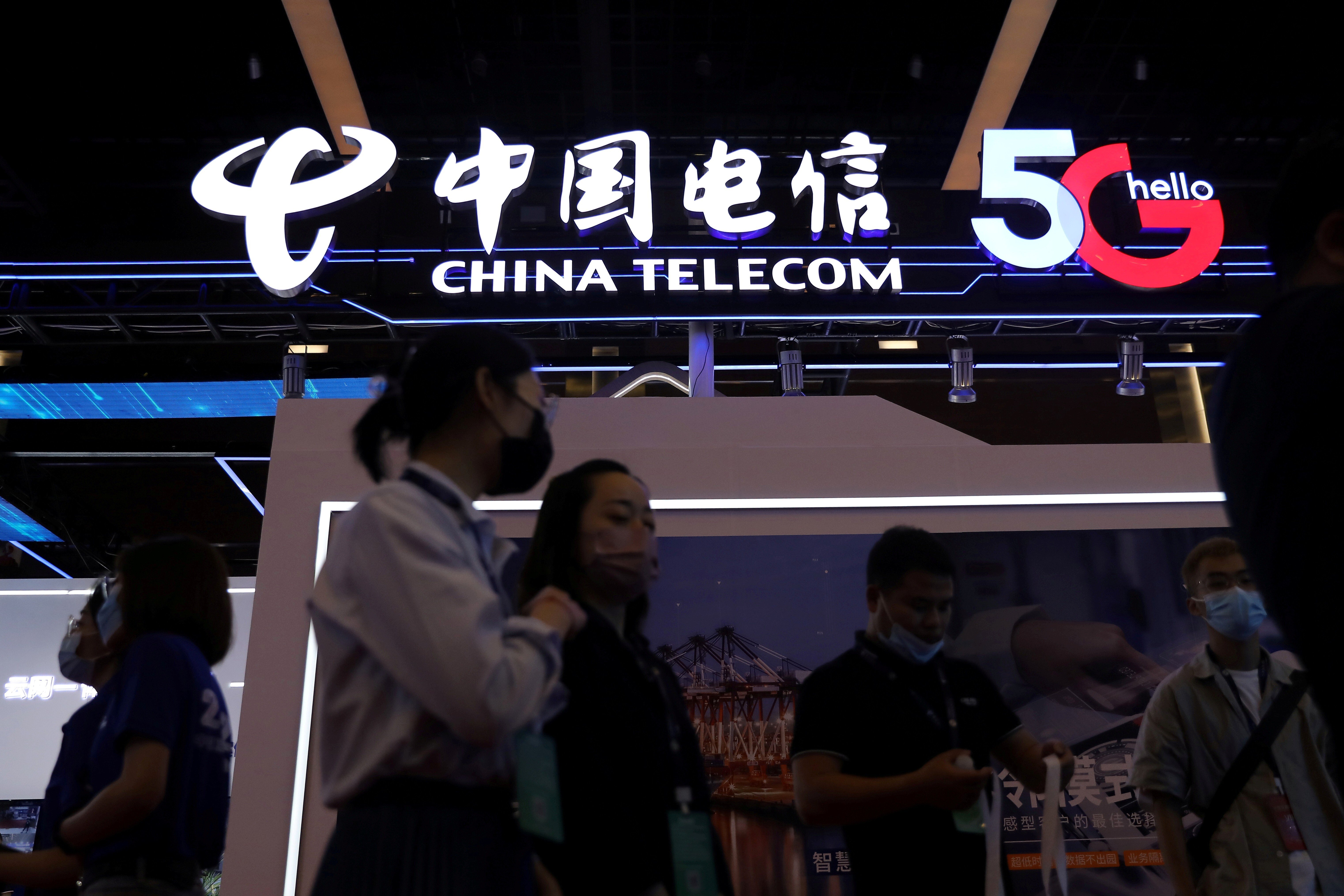 People are seen at a China Telecom booth during the 2021 China Internet Conference in Beijing in July. Photo: Reuters