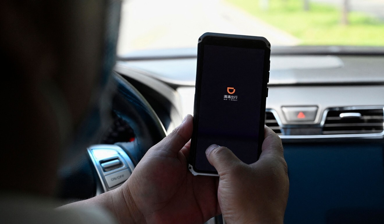 A driver opens the Didi Chuxing app on his smartphone in Beijing, in July 2021. Photo: AFP