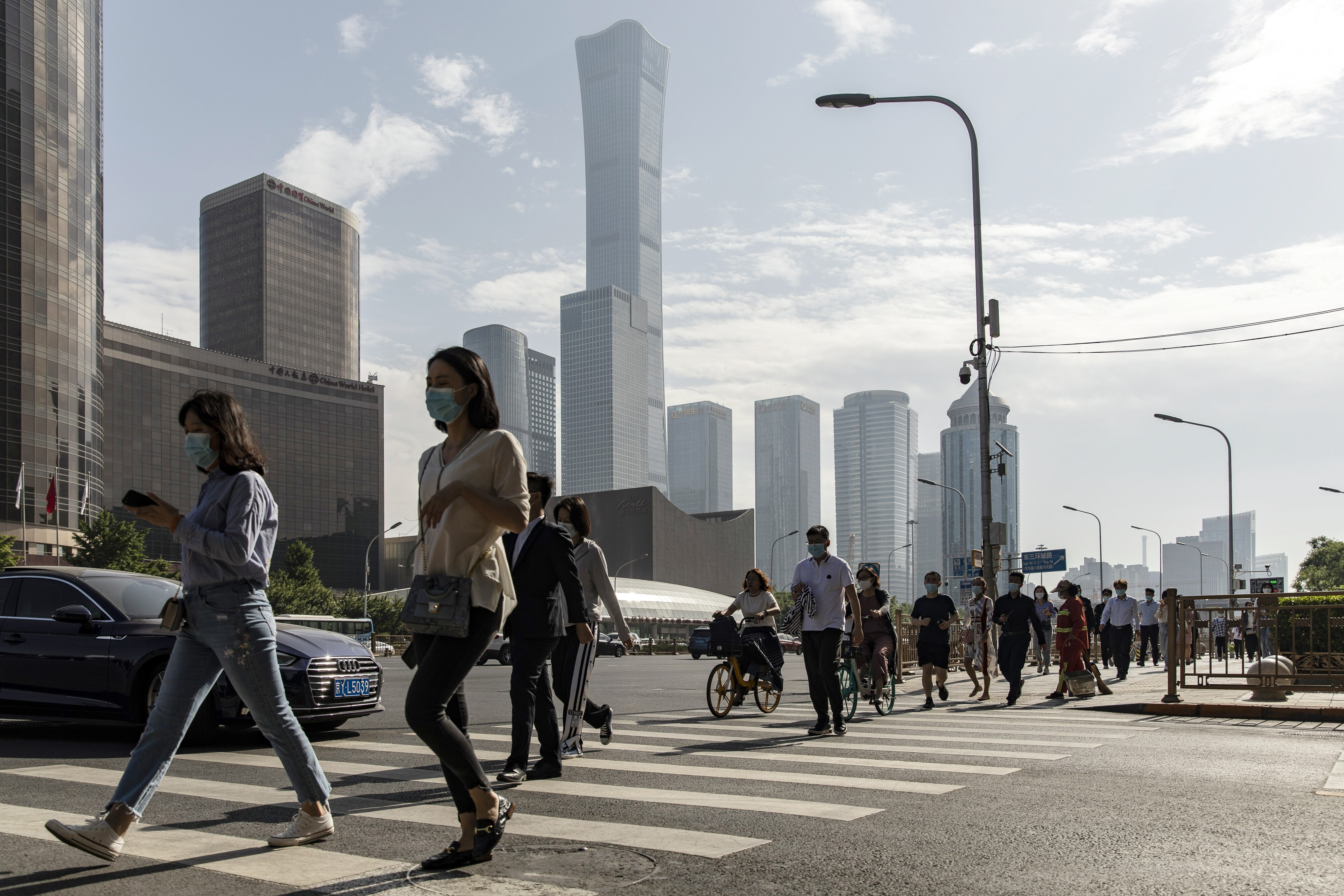 Pedestrians in the central business district of Beijing. Several Chinese banks will report their earnings on Friday. Photo: Bloomberg