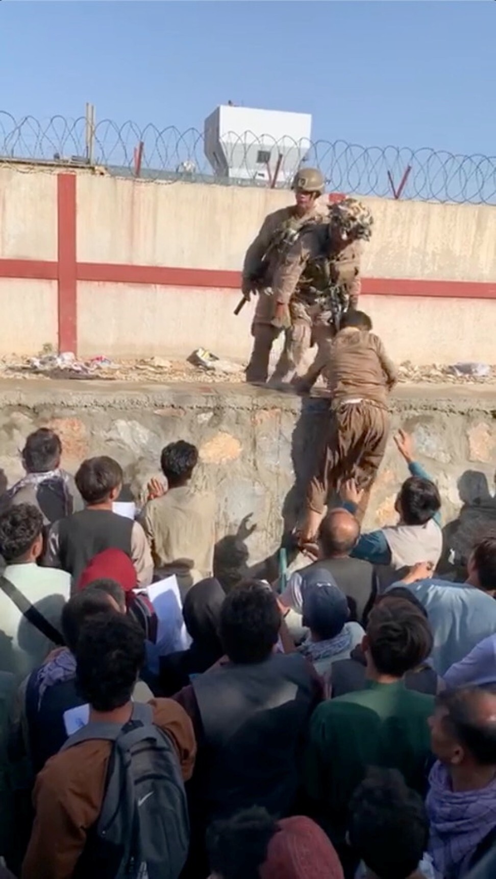 Desperate Afghans gather in knee-deep water outside Kabul airport ...