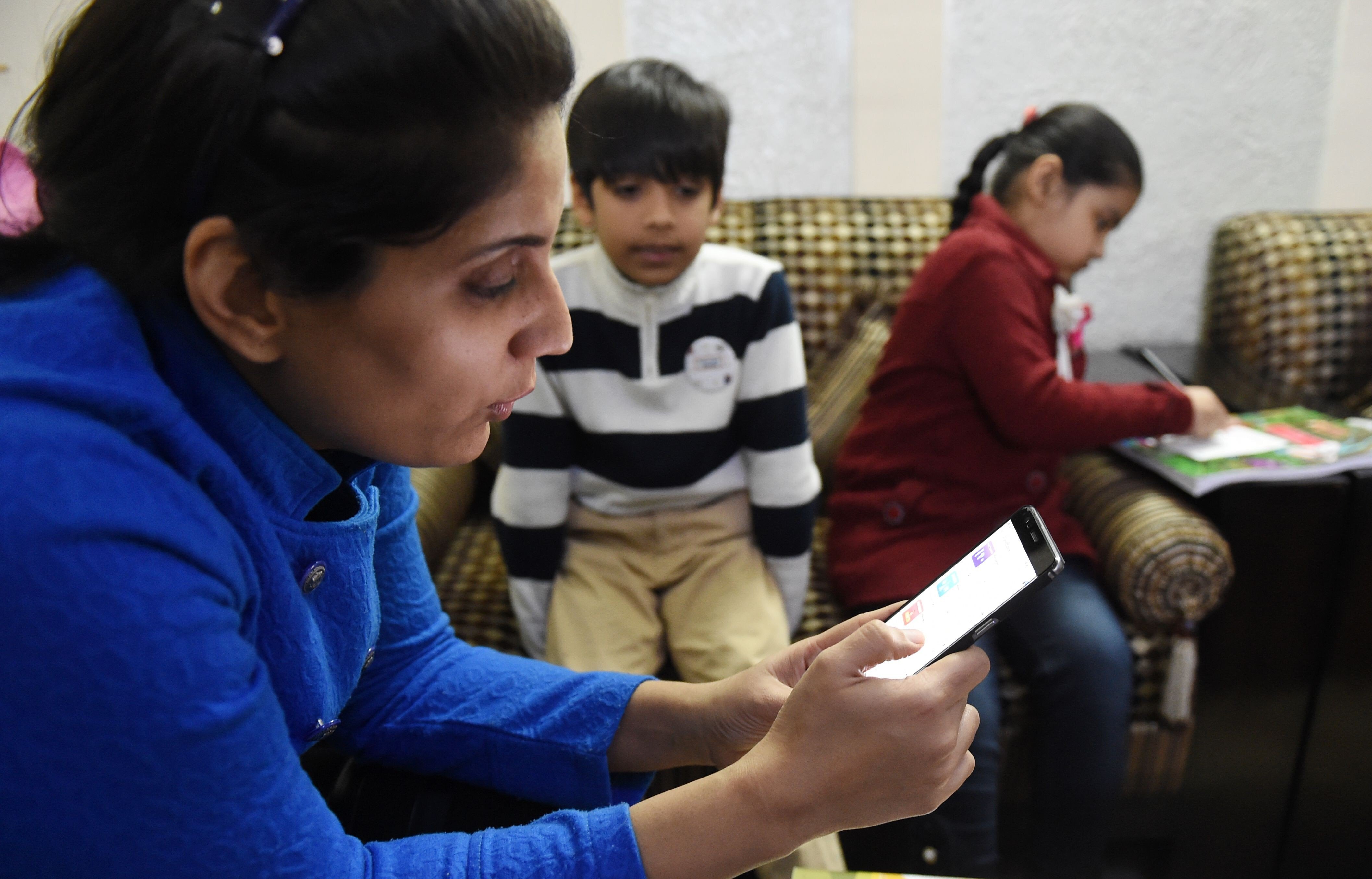 An Indian teacher uses an app that uses ‘gamified’ methods to help children learn. Photo: AFP