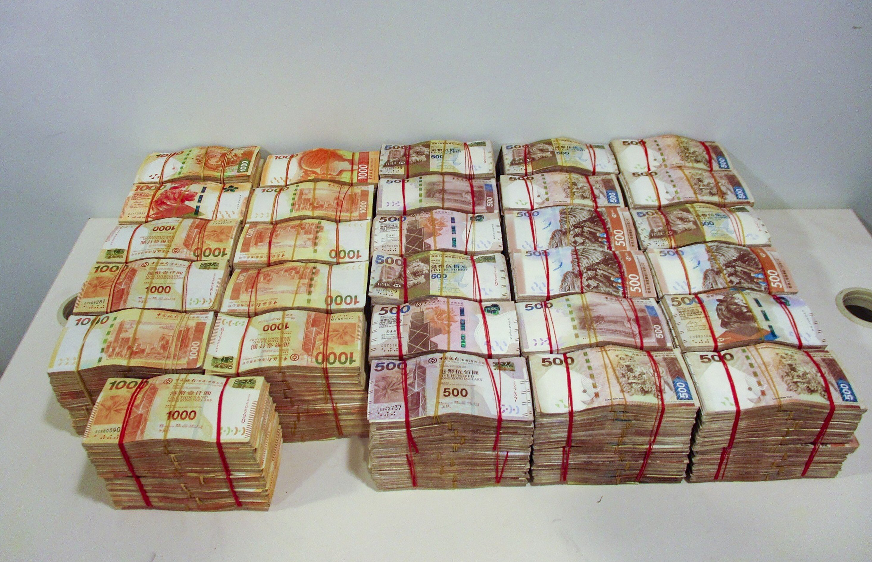 Cash seized in an operation that broke up a money-laundering ring engaged in smuggling criminal proceeds across the Hong Kong-Zhuhai-Macau Bridge. Photo: Handout