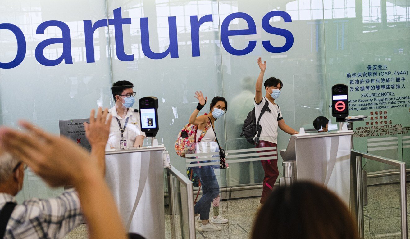 People waving goodbye at Hong Kong international airport in July. Thousands of Hongkongers have been leaving the city to settle in the United Kingdom. Photo: Getty Images