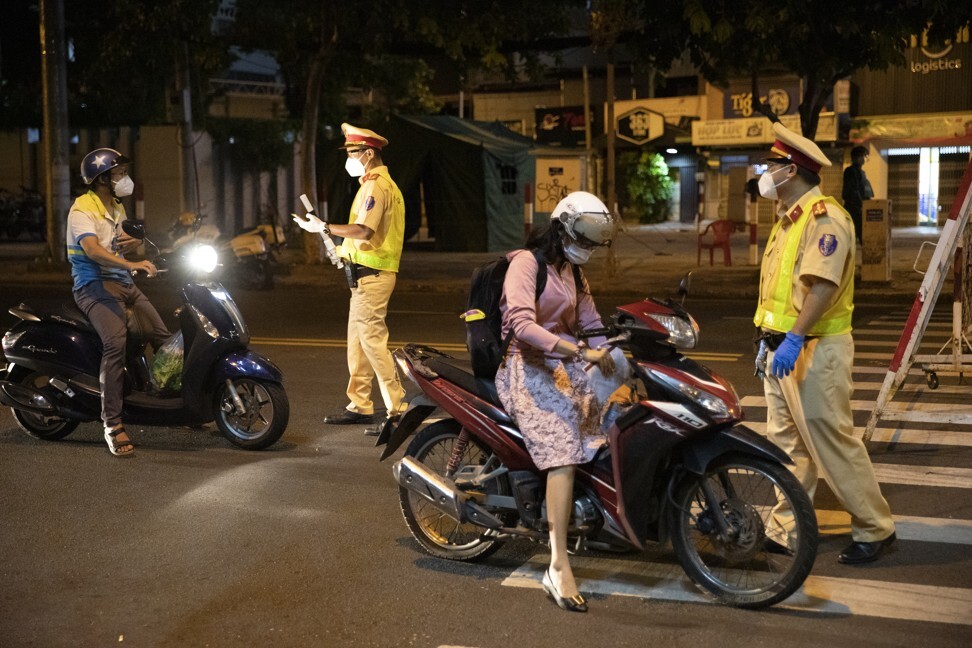 Motorcyclists are stopped at a security checkpoint in Ho Chi Minh City, which is the epicentre of Vietnam’s outbreak. Photo: Bloomberg