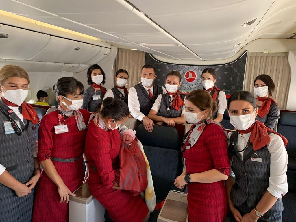 Turkish Airlines cabin crew members pose with the newborn baby girl. Photo: Turkish Airlines via Reuters