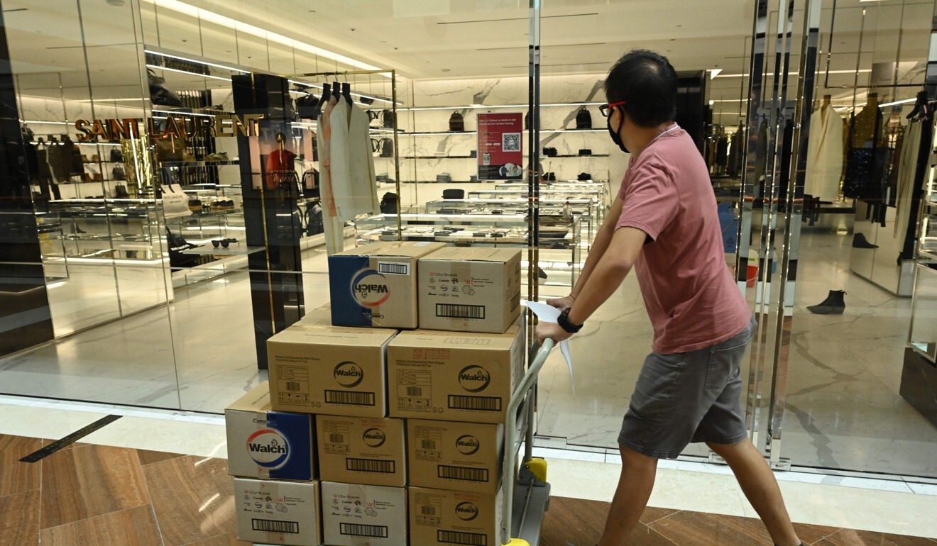 A worker pushes a trolley with goods at a shopping mall in Singapore. Photo: AFP
