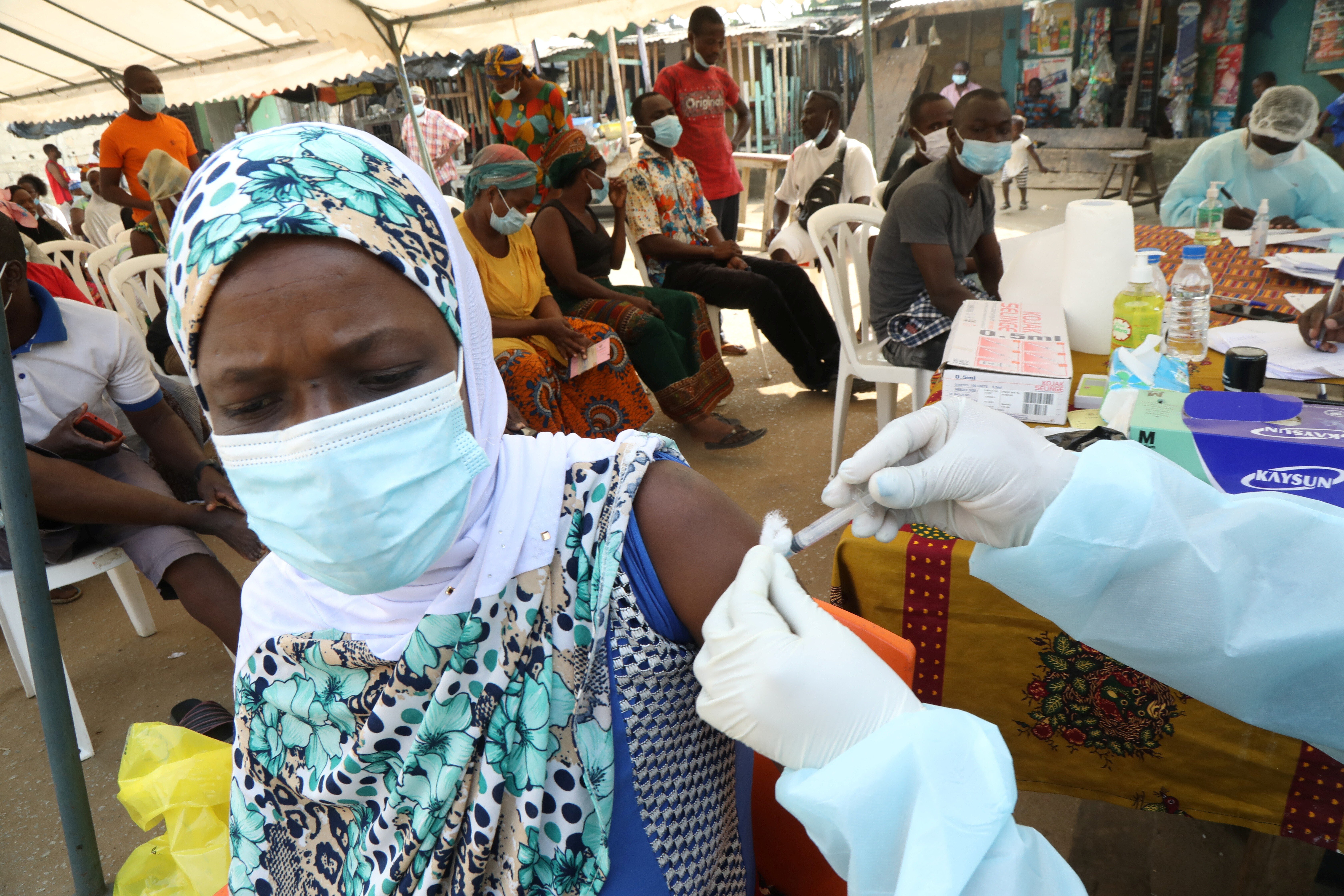 A woman receives a vaccination against Ebola in the slum of Alakro in Abidjan, Ivory Coast in August. Photo: Reuters