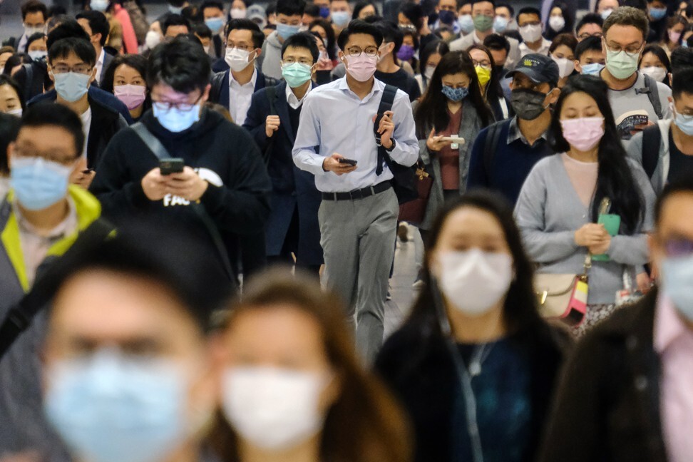 Passengers wearing protective masks walk through the Central MTR station in Hong Kong. Wealthy investors in Hong Kong and Singapore are putting greater emphasis on sustainability in their portfolios, according to St James’s Place Wealth Management Asia. Photo: Bloomberg