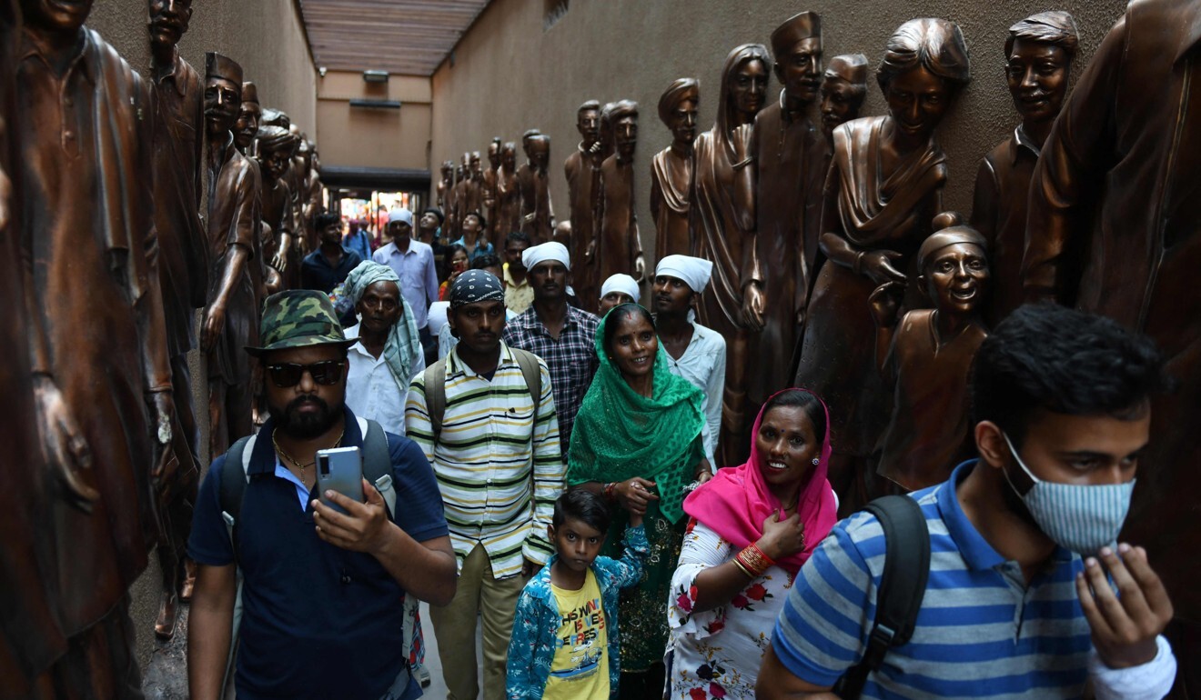 Visitors walk past sculptures at the renovated passage into the memorial. Photo: AFP