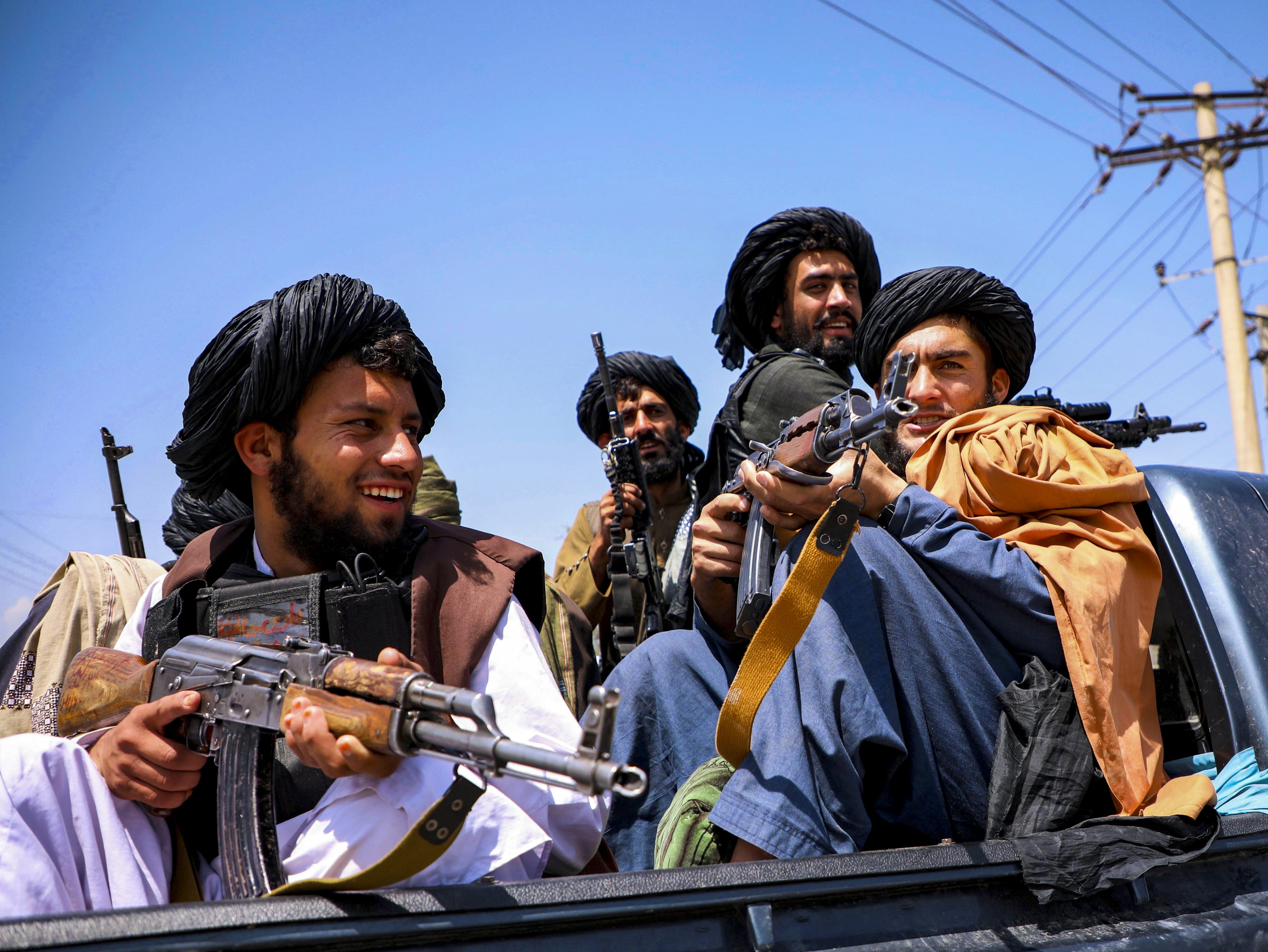 Taliban forces patrol in front of the airport in Kabul, Afghanistan, on Thursday. The situation has moved many in Hong Kong to raise funds for refugees and others affected by the crisis. Photo: Reuters