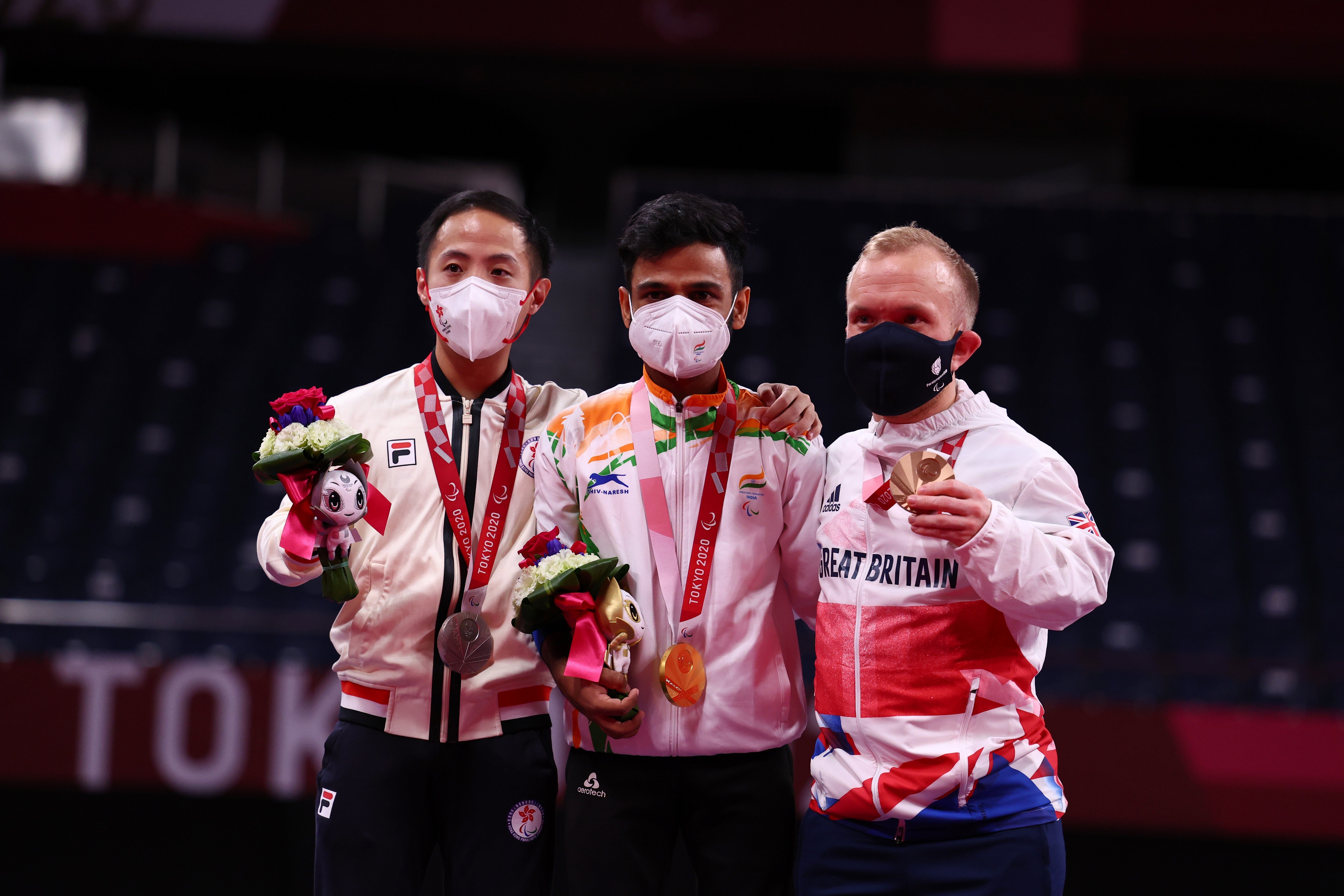 (From left) Silver medallist Chu Man-kai of Hong Kong, poses with gold medallist Krishna Nagar of India and bronze medallist Krysten Coombs of Britain on the podium. Photo: Reuters