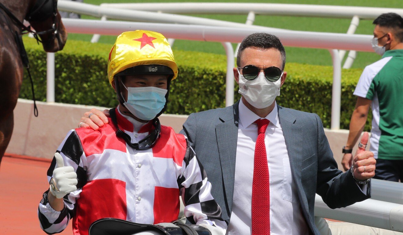 Jockey Jerry Chau and trainer Douglas Whyte celebrate First Responder’s victory.