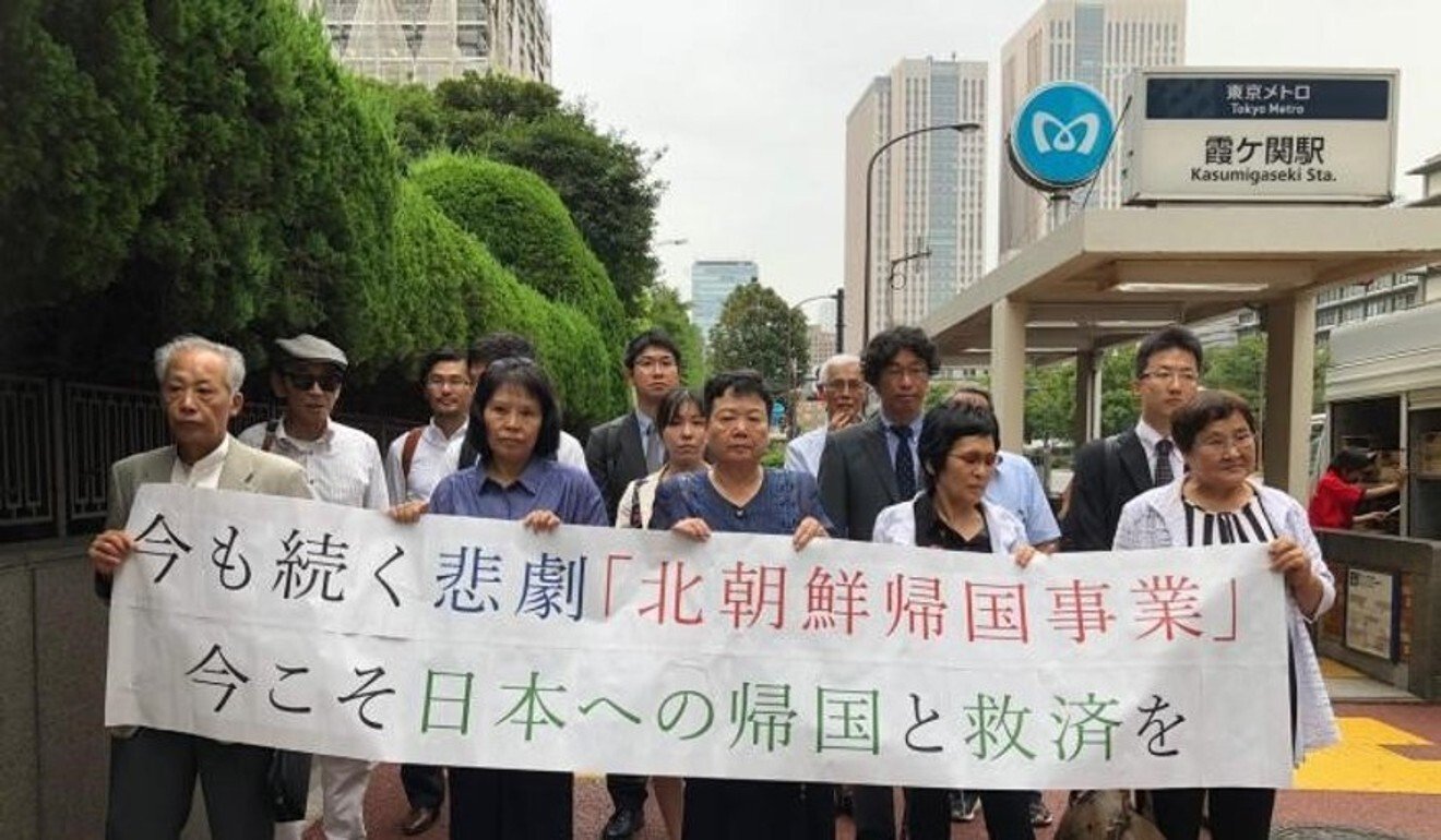 Eiko Kawasaki, middle front row, and other plaintiffs walk to court for a hearing of the case. Photo: Handout