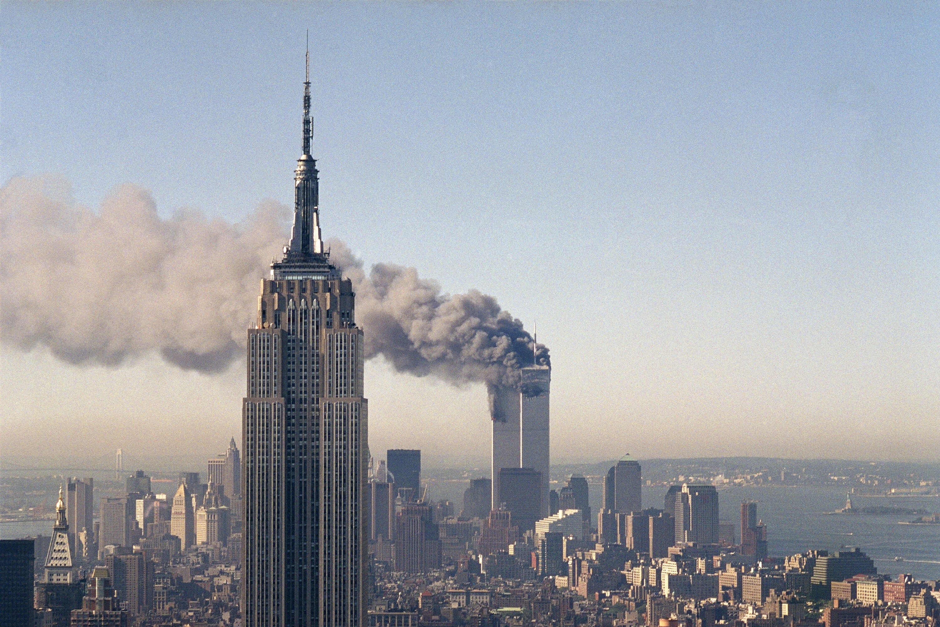 The twin towers of the World Trade Centre burn behind the Empire State Building on September 11, 2001. Photo: File, AP