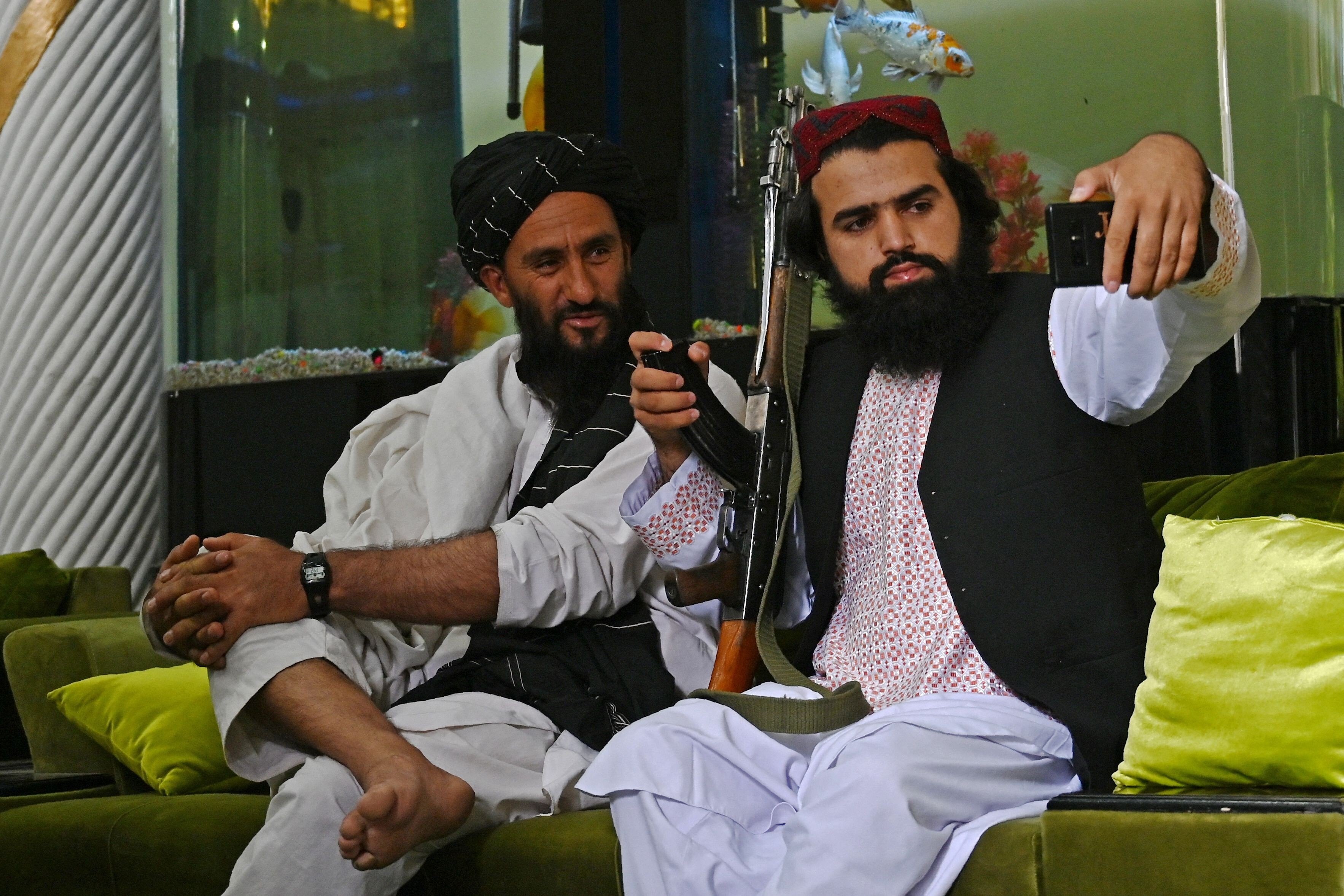 Taliban fighters take a selfie with a mobile phone after seizing the mansion of Afghan warlord Abdul Rashid Dostum. Photo: AFP