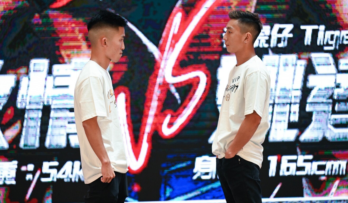 Hong Kong boxer Raymond Poon Kai-ching (left) in his face-off against former national Muay Thai champion Dylan Yiu Tat-fai at the We Are Champs 2021 crossover pre-event press conference. Photo: We Are Champs