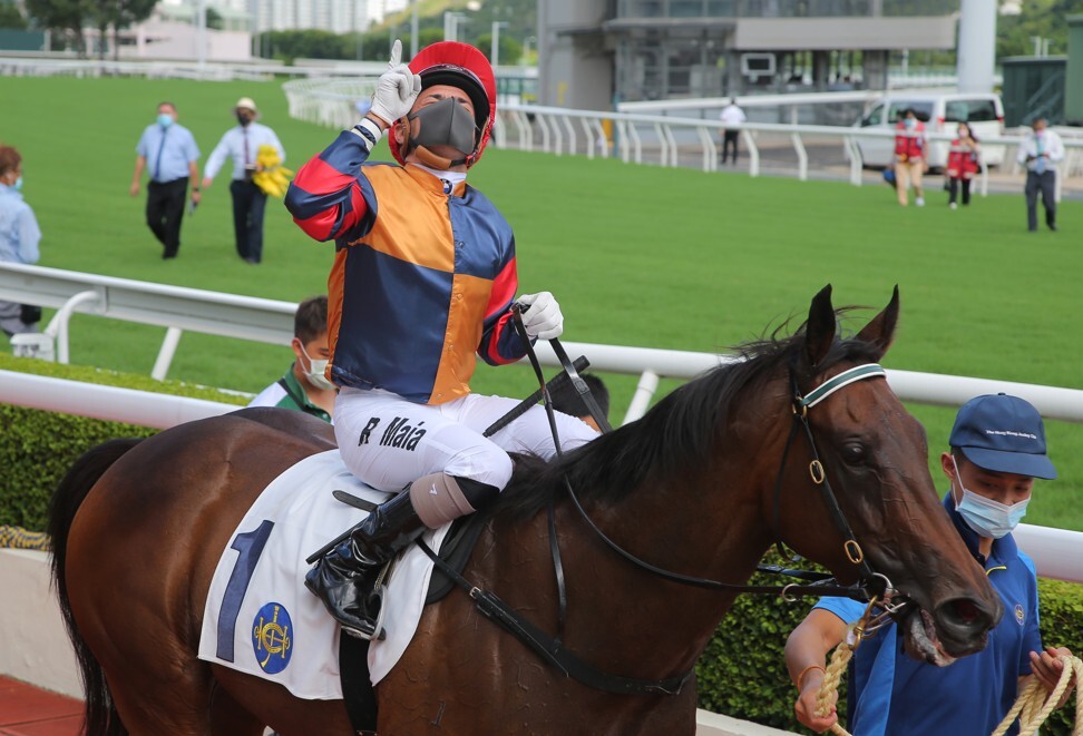 Ruan Maia points to the sky after winning aboard Lucky Maryknoll on opening day.