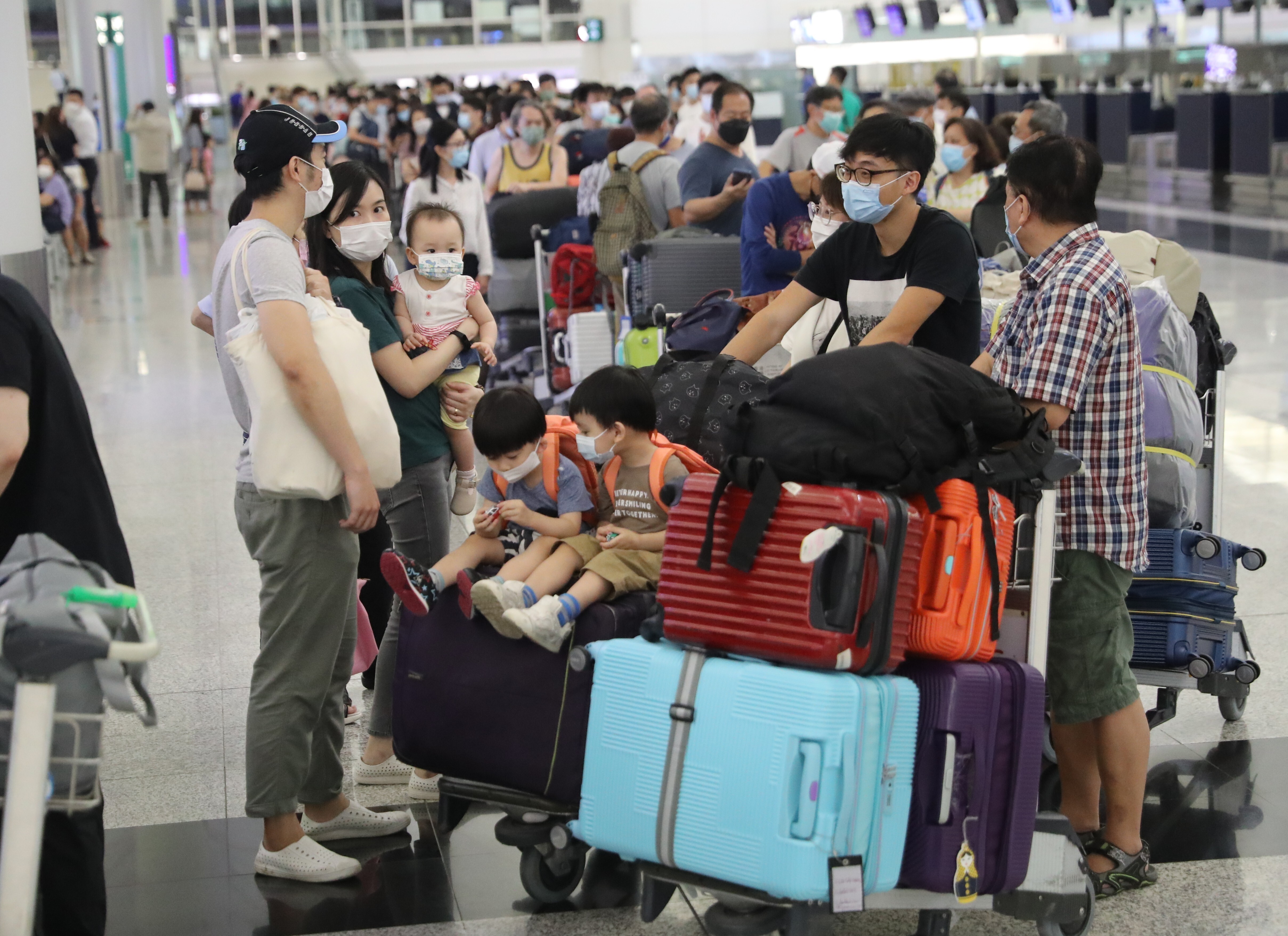 Passengers wait at check-in counters at Hong Kong International Airport. Photo: Edmond So