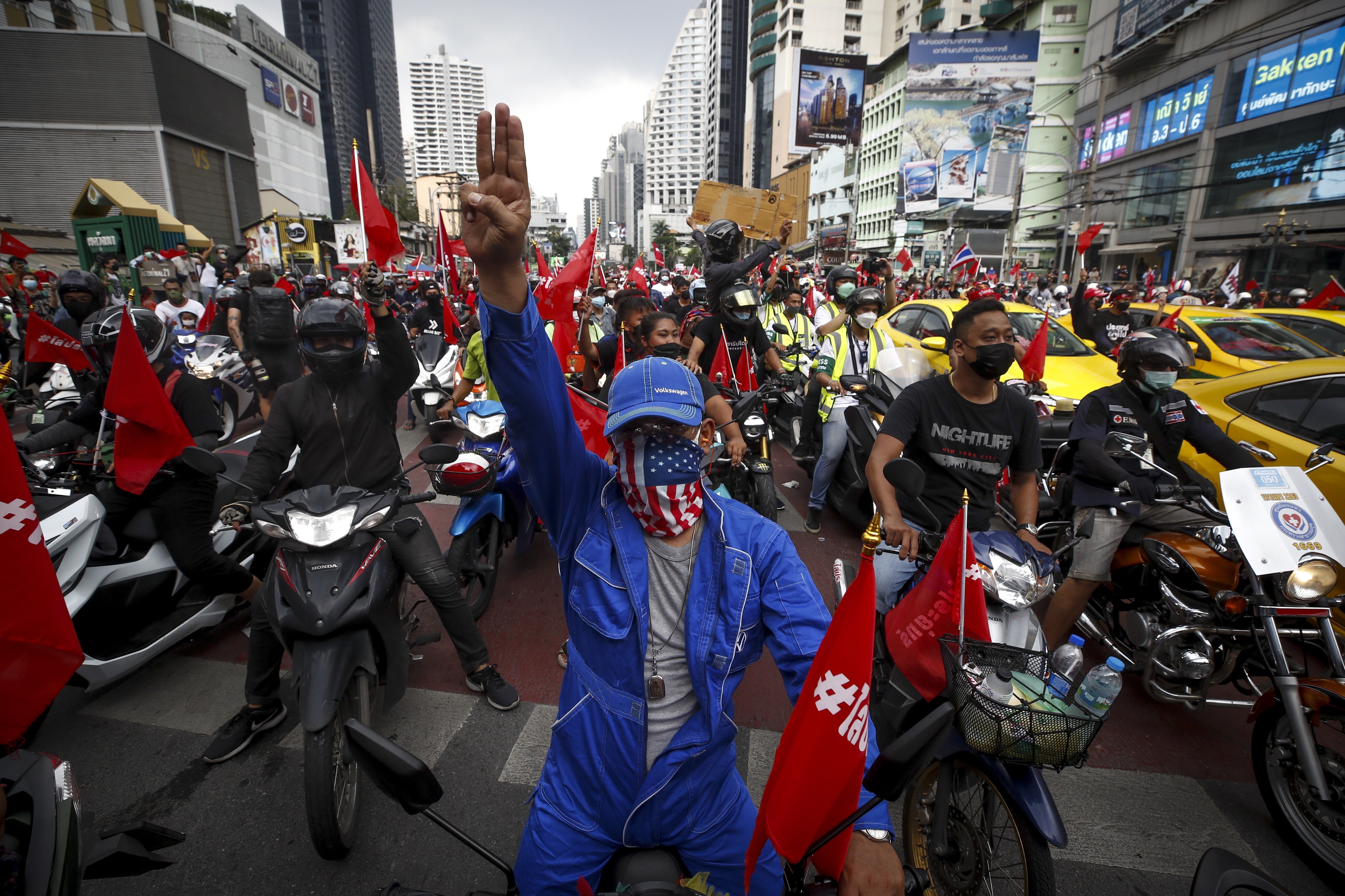 Anti-government protesters displayed the three-finger salute at a rally calling for the resignation of the prime minister in Bangkok. Photo: EPA