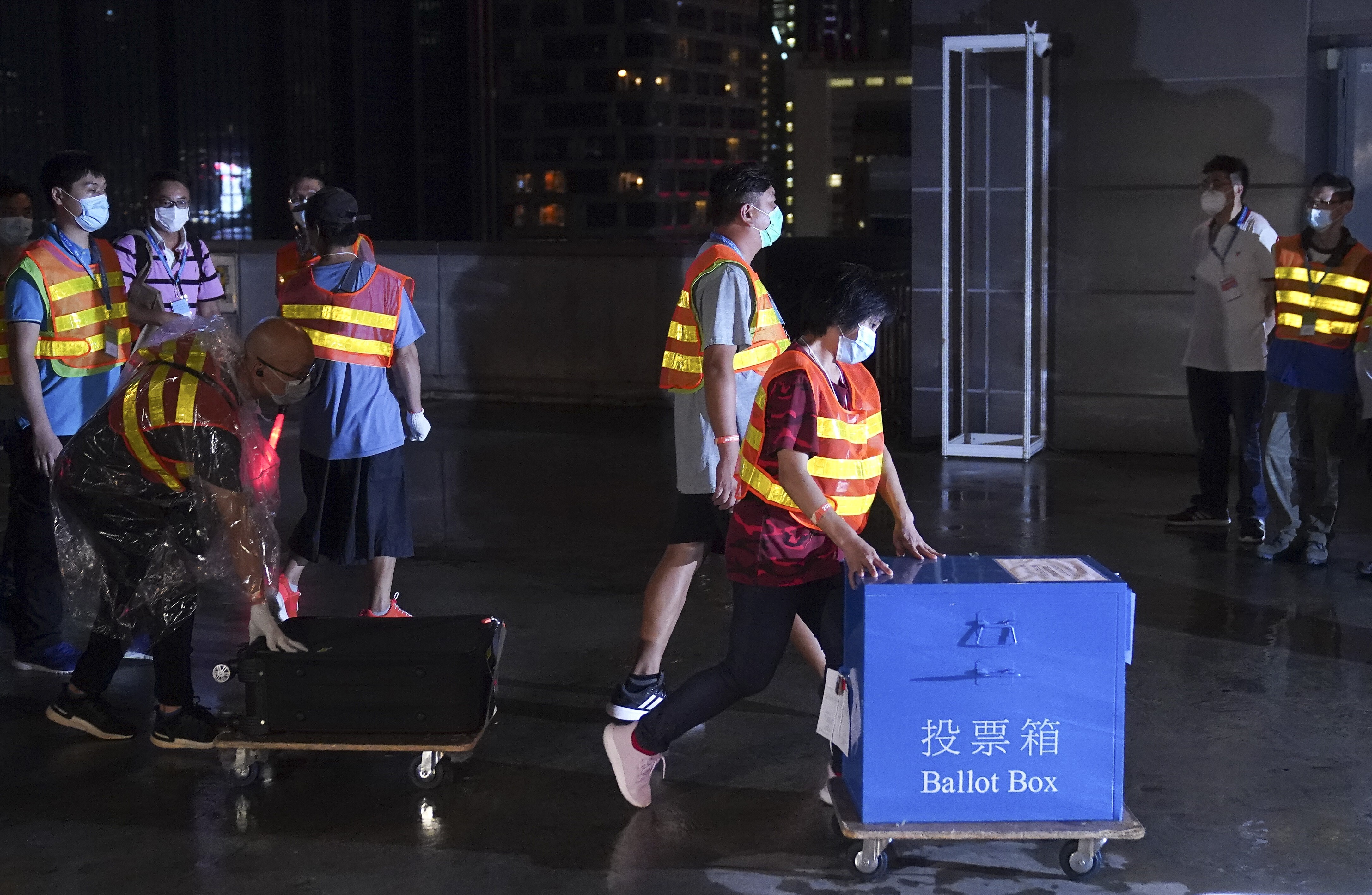 Government officers transport a ballot box at the polling station in Wan Chai on Sunday. Photo: Sam Tsang