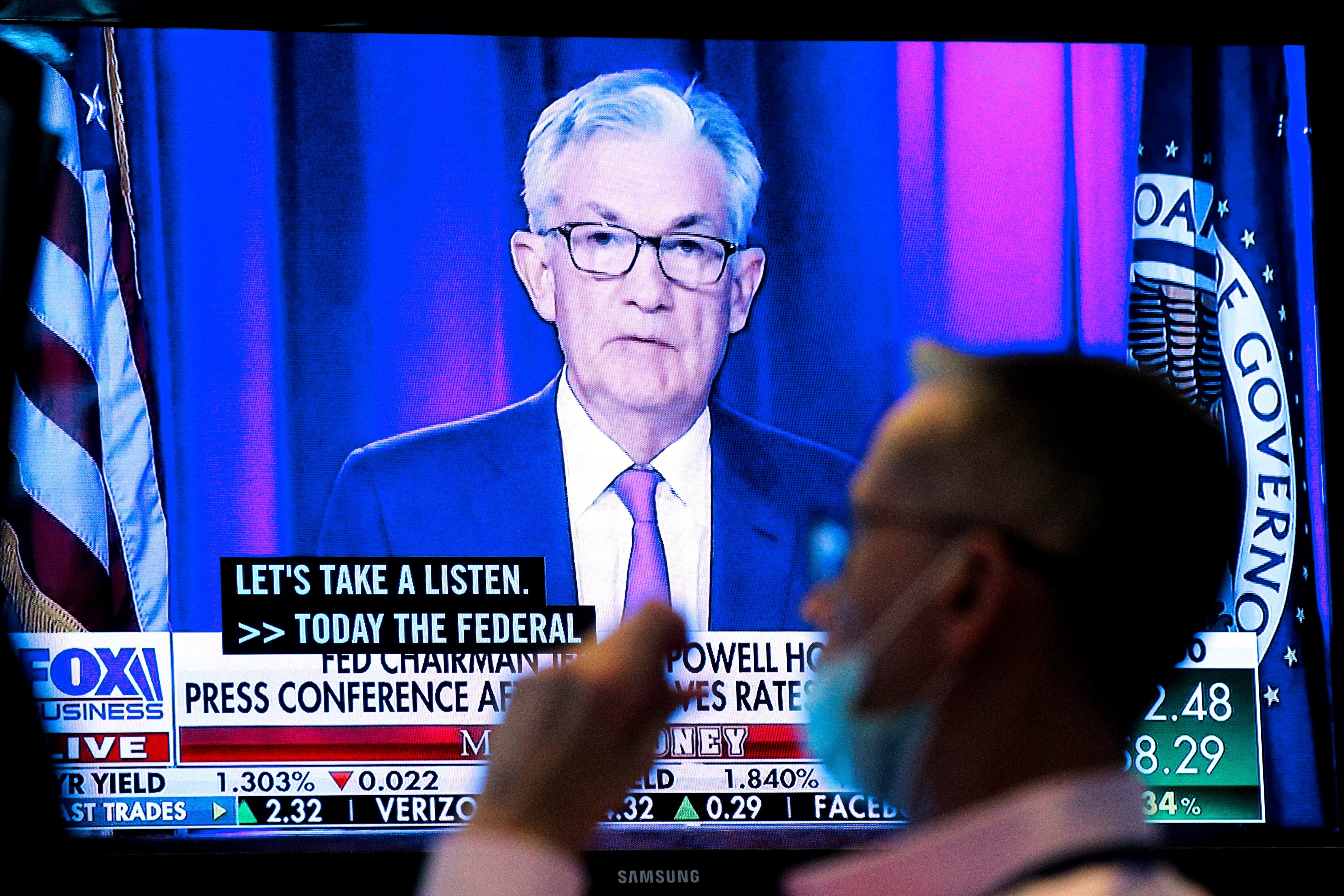 A screen displays a statement by Federal Reserve Chair Jerome Powell as a trader works on the floor of the New York Stock Exchange on Wednesday. Photo: Reuters