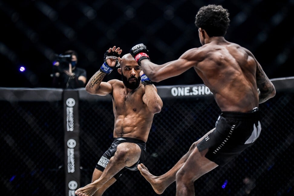 Demetrious Johnson looks to avoid a leg kick by Adriano Moraes.