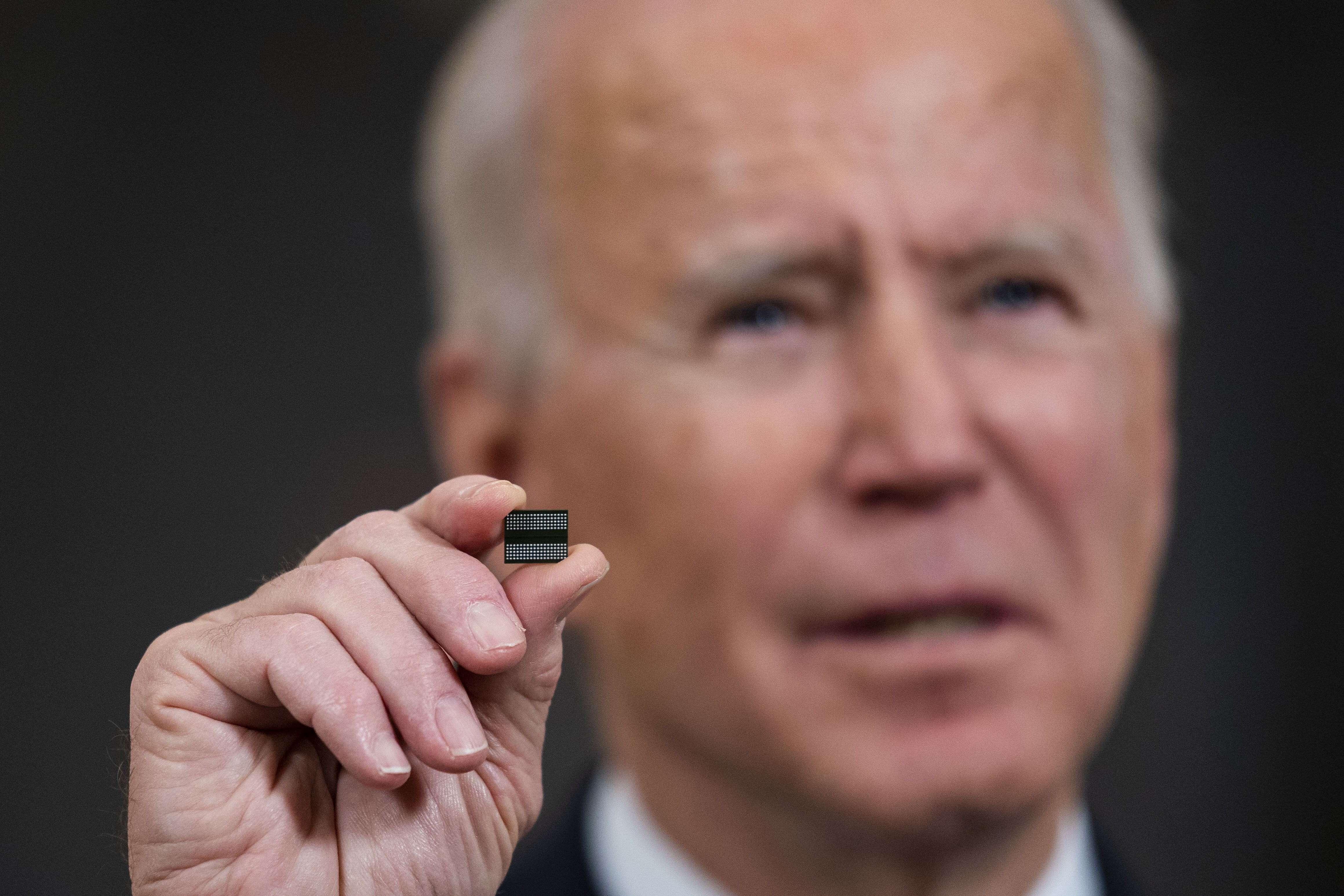 US President Joe Biden holds a semiconductor during his remarks before signing an executive order on the economy in the State Dining Room of the White House on February 24 in Washington. Photo: AFP