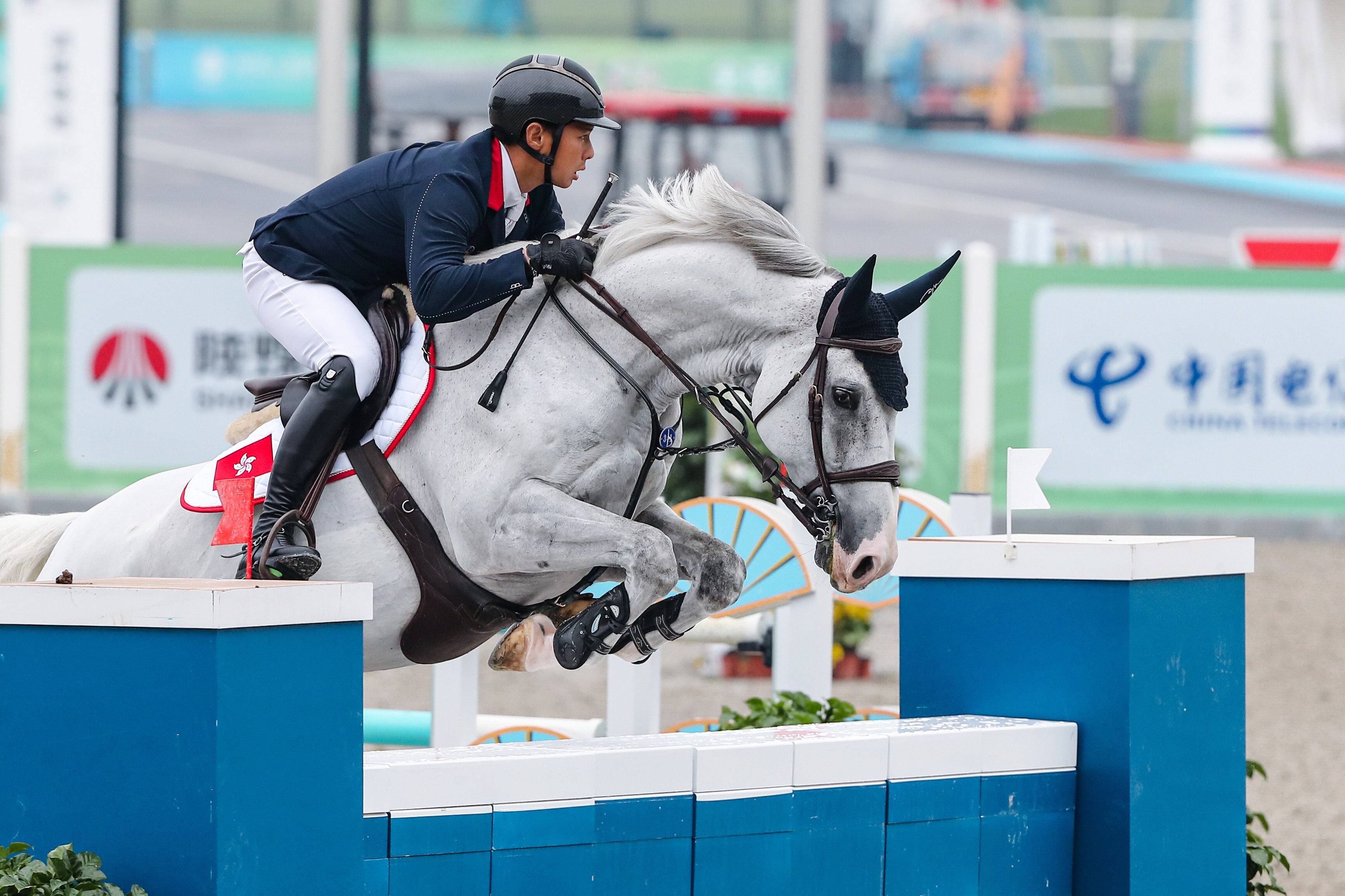 Hong Kong’s Kenneth Cheng and his horse Funchal in the showjumping qualifiers at the National Games in Xian. Photo: LCSD/Sports Road)