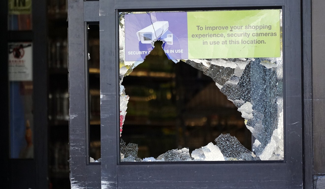 A door with broken glass stands open in the entrance of a Kroger grocery store in Tennessee on Friday. Photo: AP