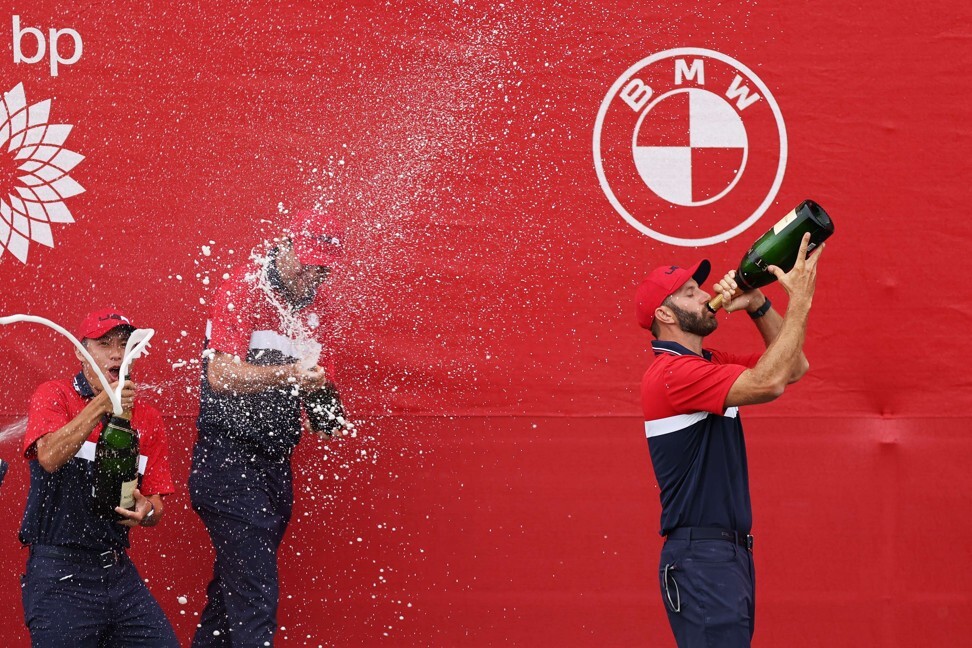 Dustin Johnson celebrates with champagne after defeating team Europe at the Ryder Cup. Photo: AFP