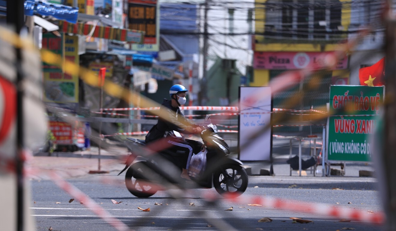 A man rides a scooter past road barricades in Vung Tau, just outside Ho Chi Minh City. Photo: AP