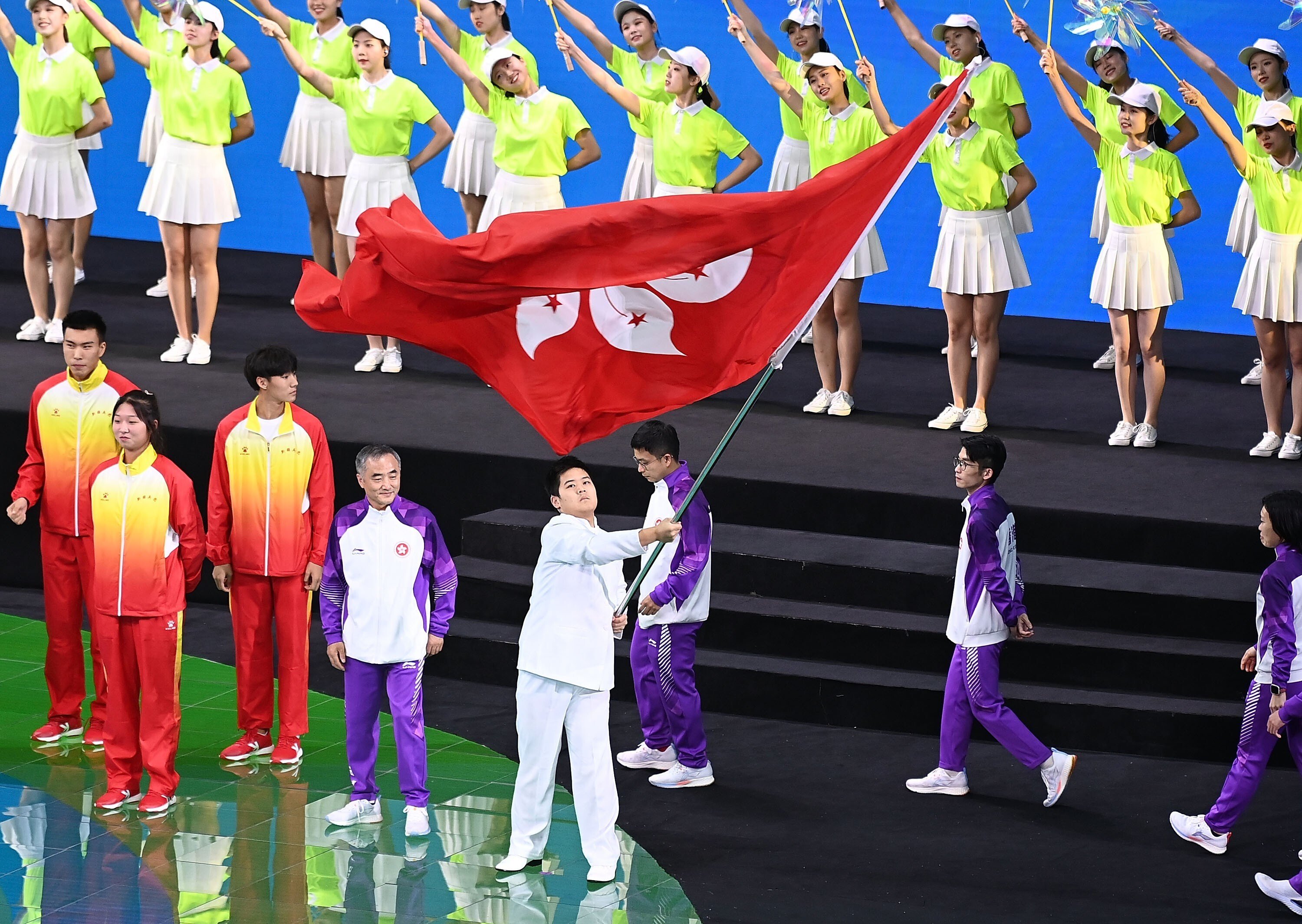 A representative from Hong Kong waves the special administrative region’s flag during National Games closing ceremony in Xian on Monday night. Photo: Xinhua