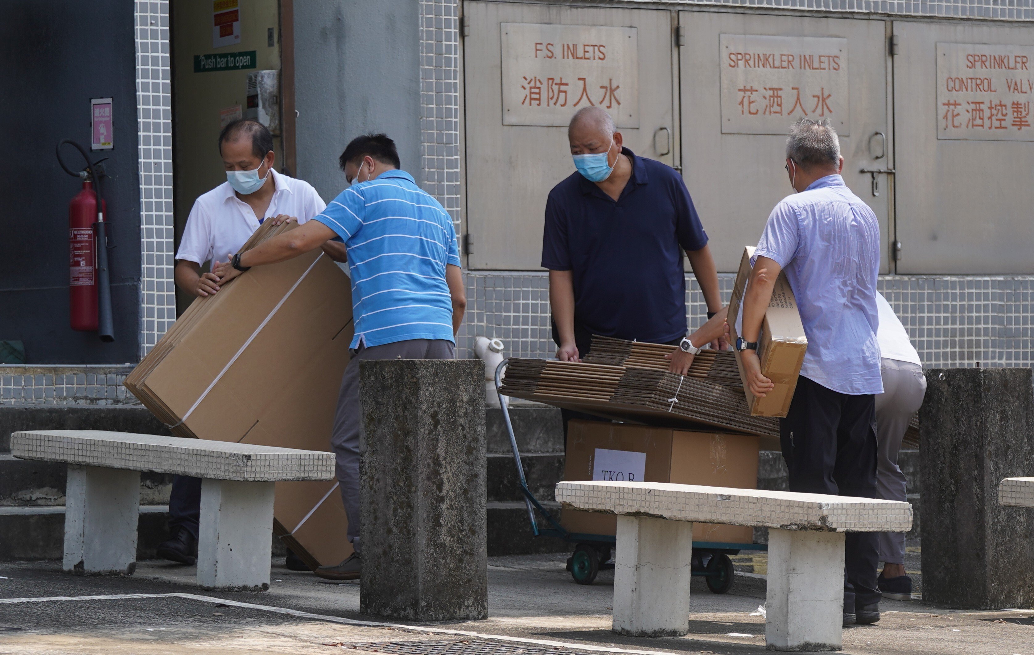 Workers removing boxes of financial records from the Next Digital Building in Tseung Kwan O on September 28, 2021 after the Hong Kong government-appointed special inspector obtained a search warrant to seize documents from the publisher of the now-defunct Apple Daily newspaper. Photo: Sam Tsang.