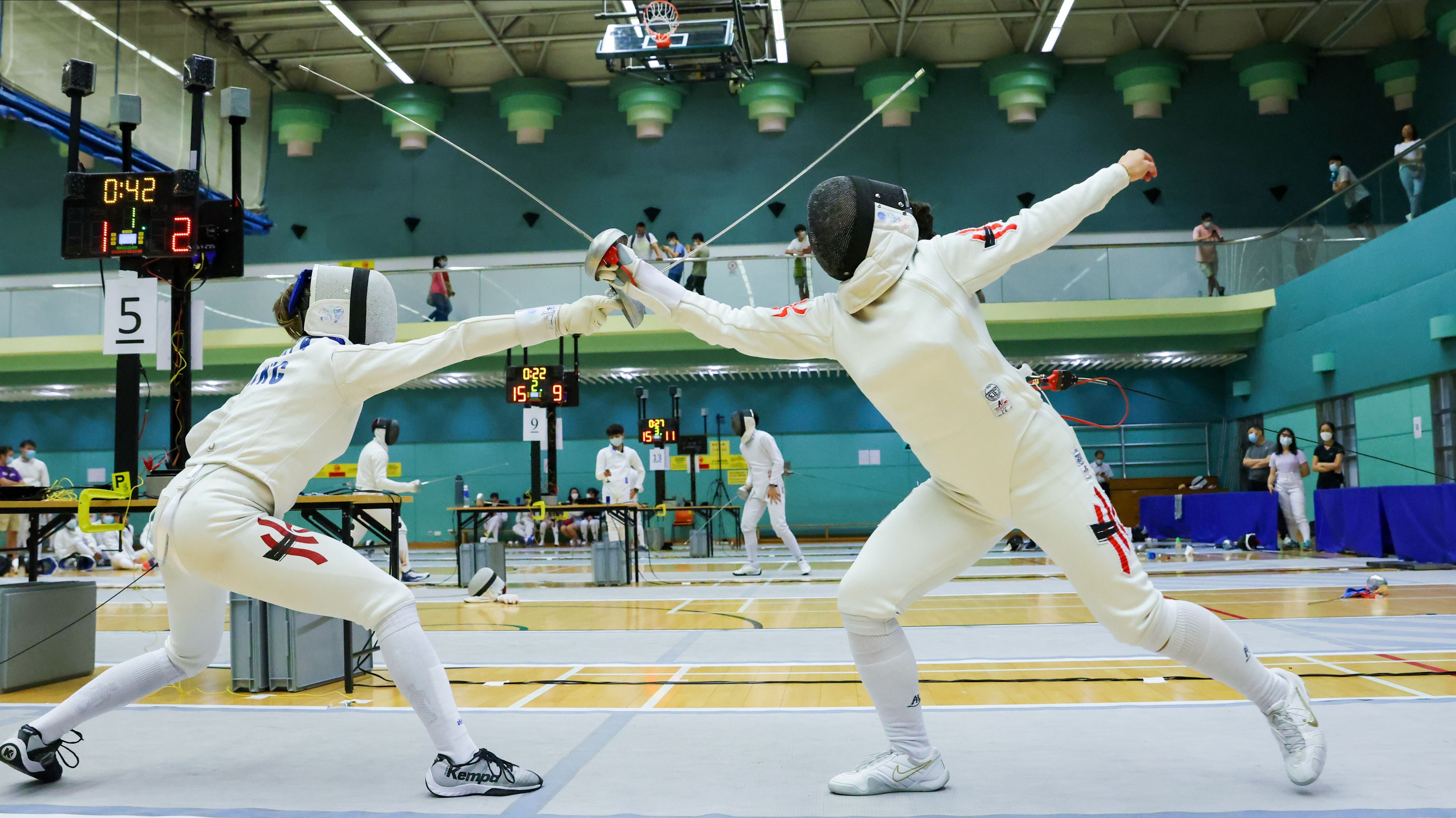 Coco Lin Yik-hei (left) takes on Debbie Ho Tik-lam (right) at the LCSD Fencing Championships quarter-finals at Hong Kong Park Sports Centre. Photo: Nora Tam