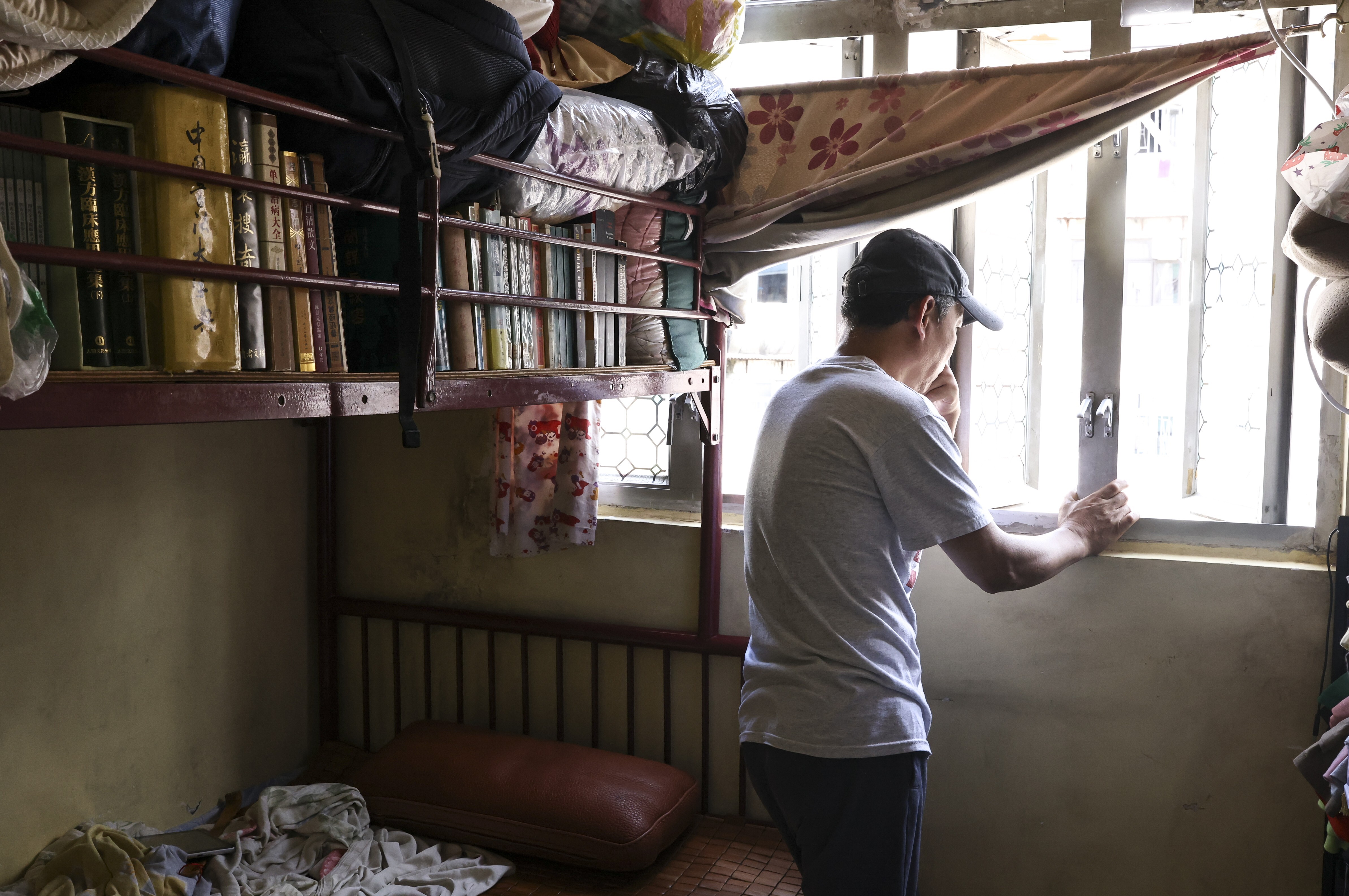 Mainland immigrant Mr Wei sits in his subdivided flat in Hong Kong’s Sham Shui Po neighbourhood. Photo: K. Y. Cheng