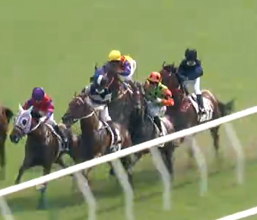 Carroll Street (green and orange silks) narrowly avoids going through the rail.