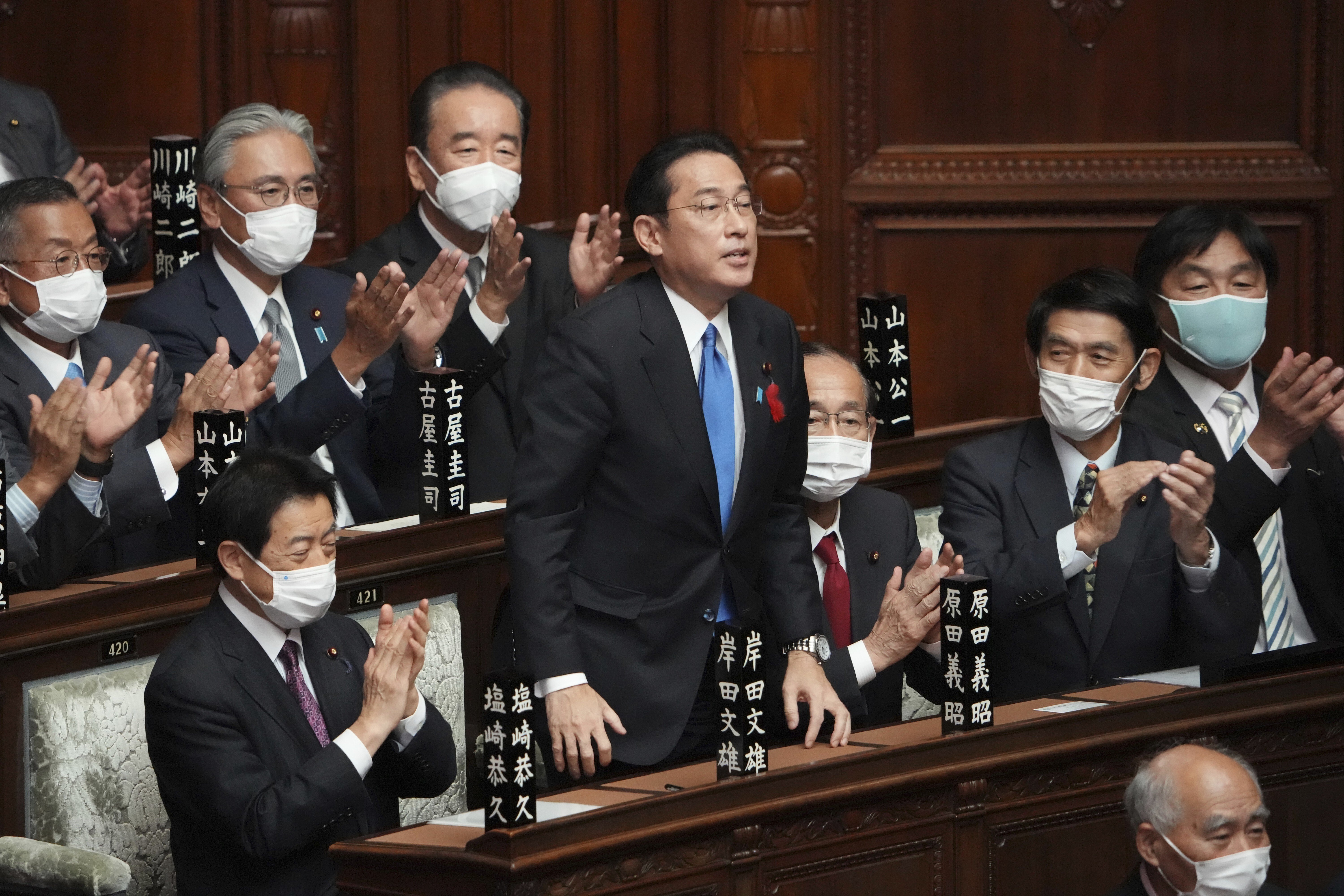 Fumio Kishida, standing, is applauded after being elected as Japan’s new prime minister at the parliament's lower house on Monday. Photo: AP