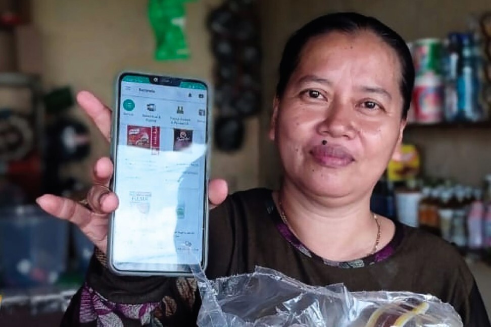 A vendor shows the e-commerce app developed by Indonesia start up Ula. Photo: Handout