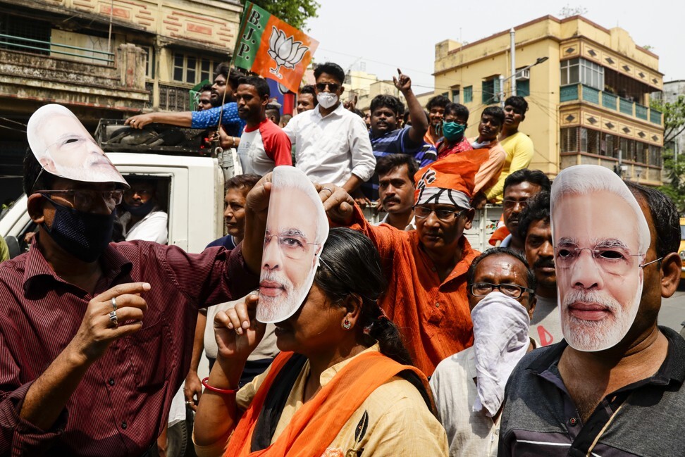 BJP supporters wearing Modi masks take part in a rally in Kolkata. Photo: AP