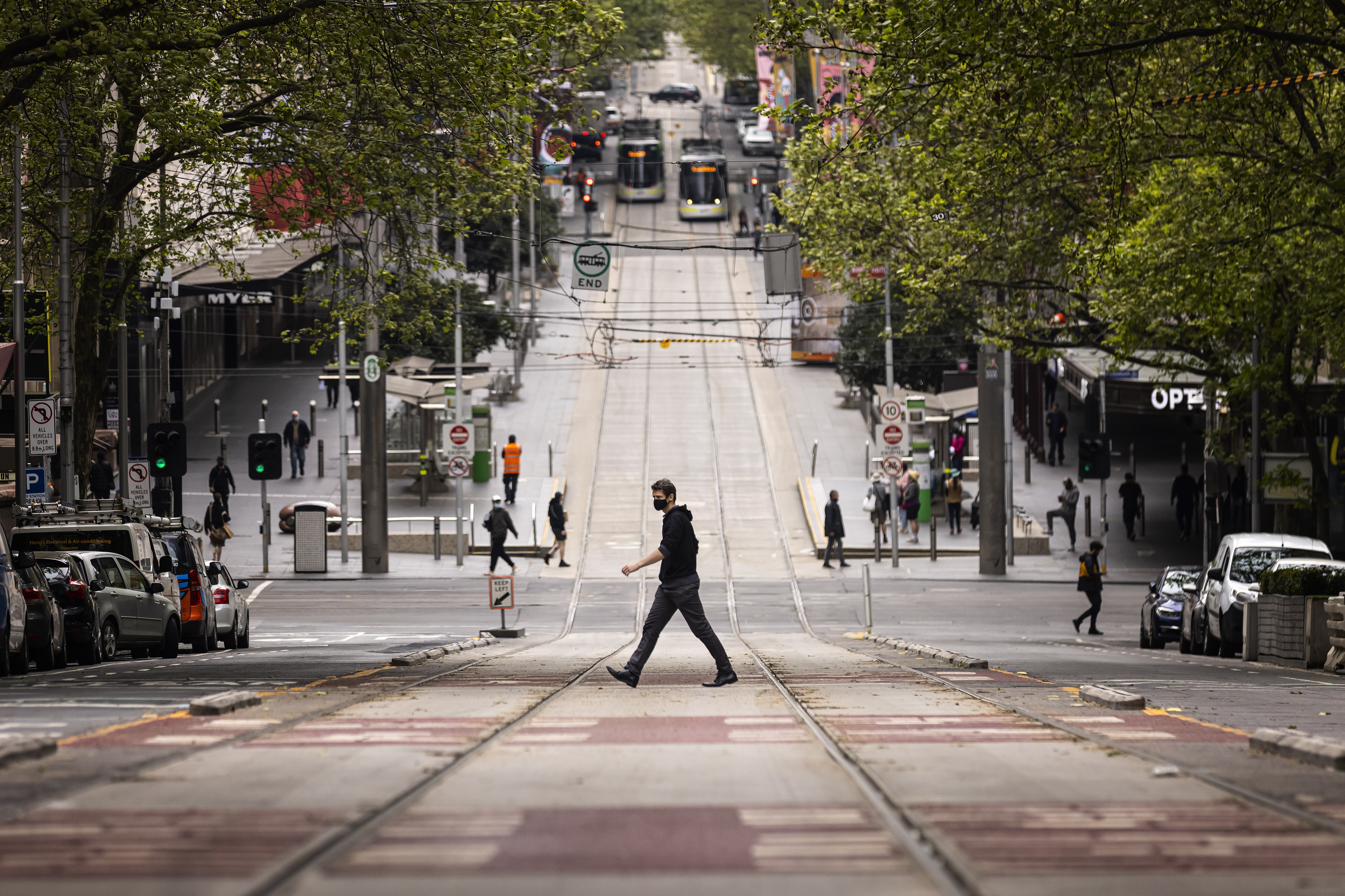 A pedestrian crosses Bourke Street in Melbourne, Australia. Photo: AP