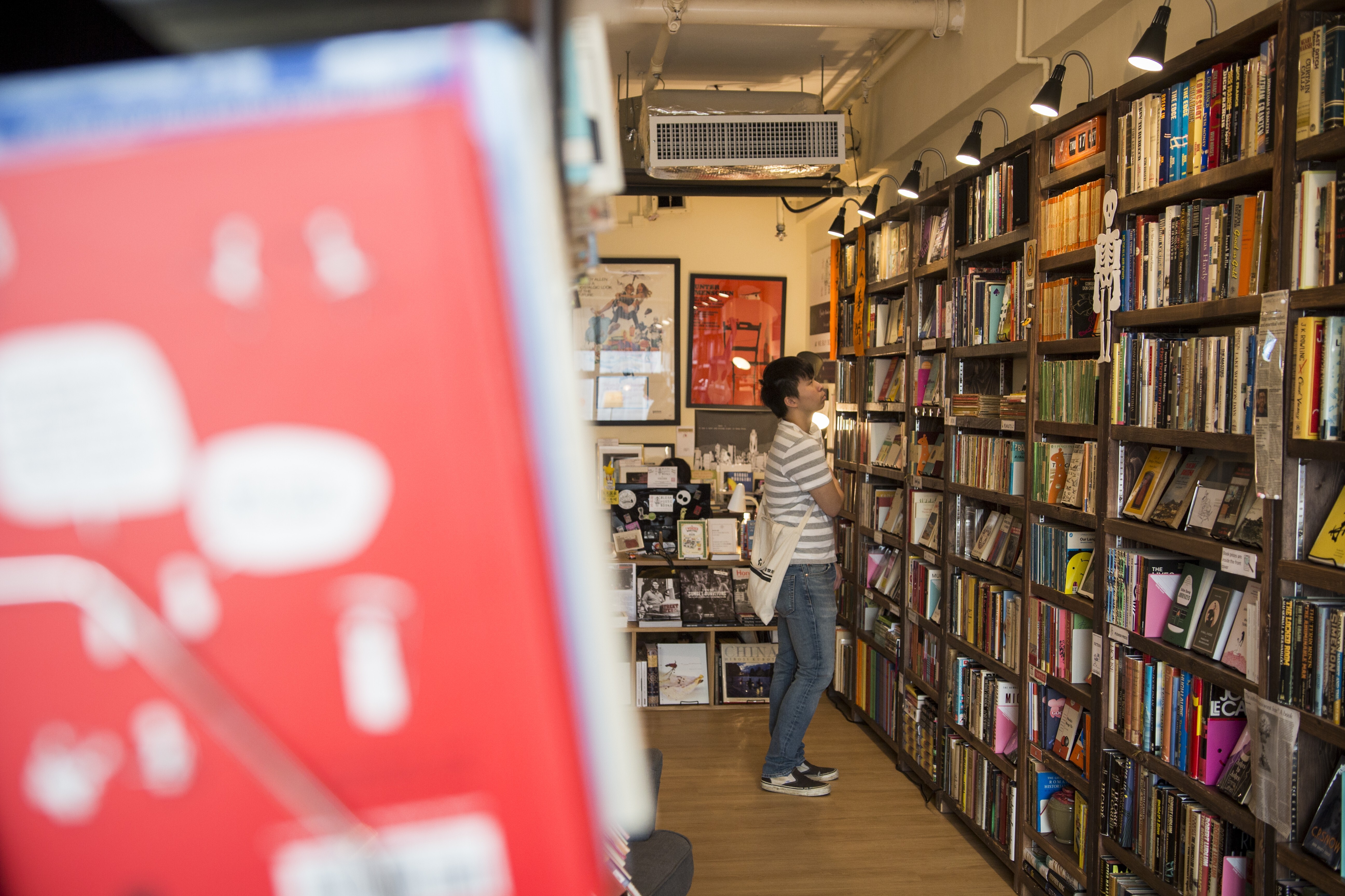 A customer browses the shelves inside Bleak House Books. Photo: Christopher DeWolf