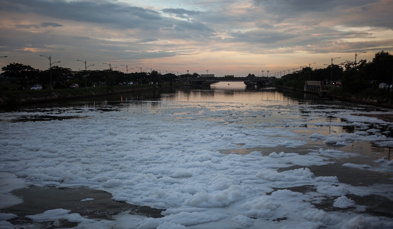 Toxic white foam flows in the polluted Jakarta Bay. Photo: Barcroft Media via Getty Images