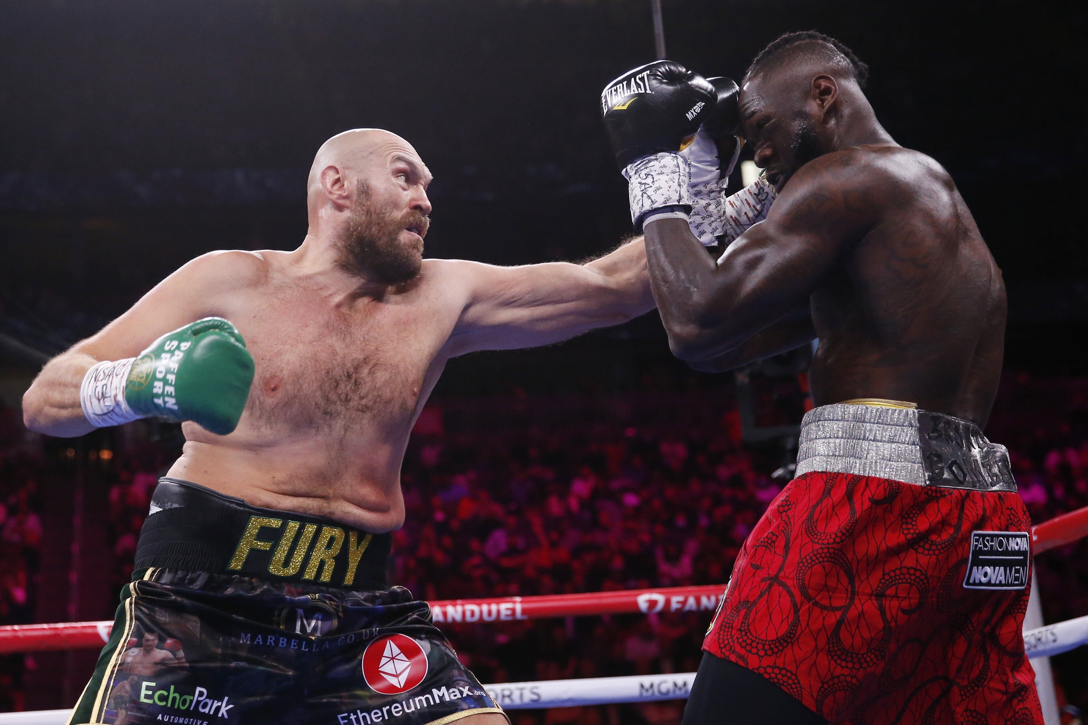 Tyson Fury lands a jab on Deontay Wilder in their heavyweight championship fight. Photo: AP