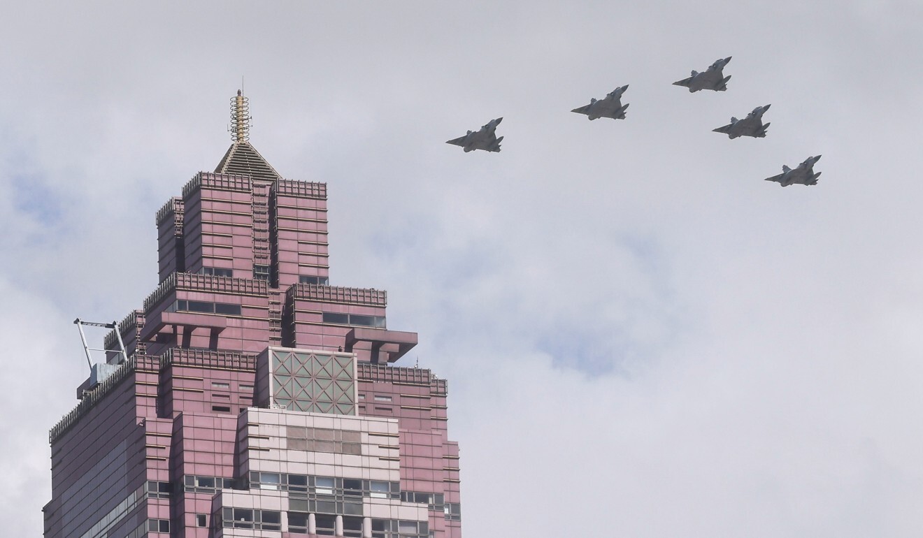 A formation of military planes conduct a flyover in Taipei. Photo: Reuters
